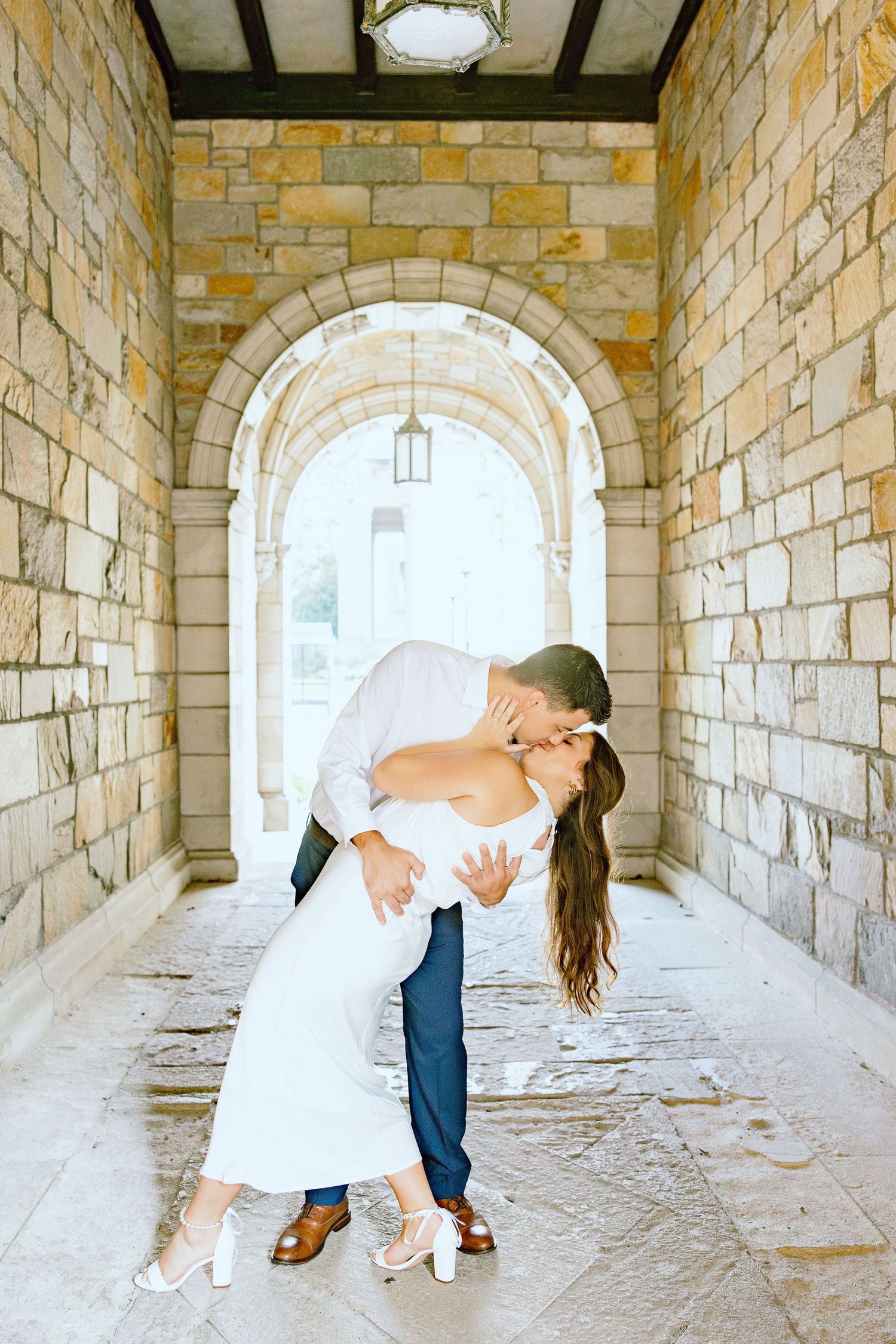 Engaged couple dipping and kissing at the UM Law Quad engagement session in Ann Arbor, MI