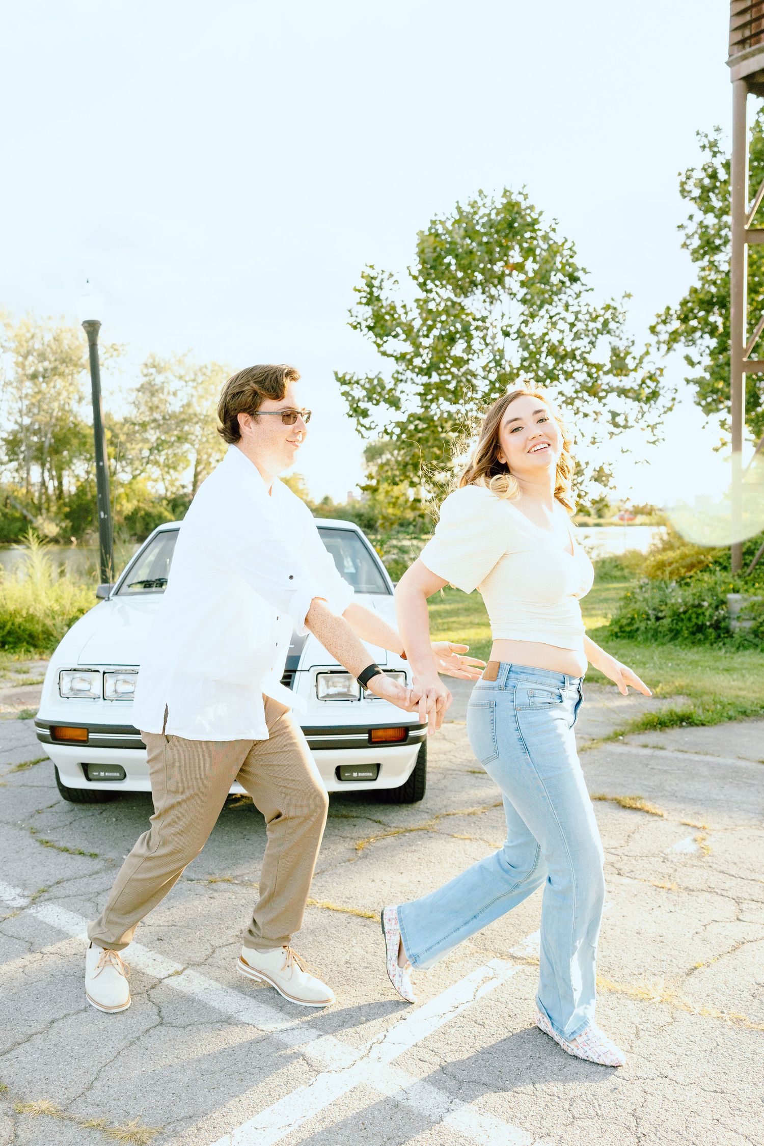 Engaged couple swing dancing at Belle Isle summer engagement session in Detroit, MI