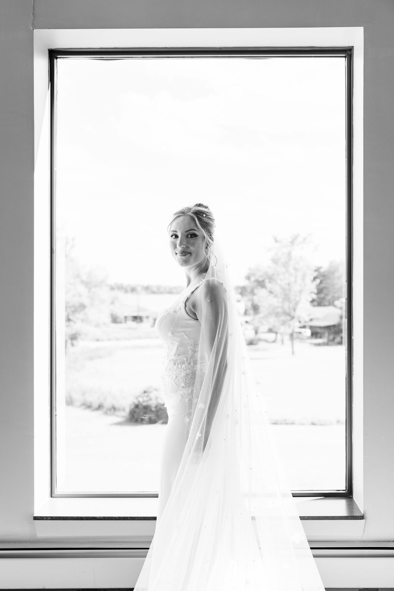 Bride portrait in front of window at Lapeer Country Club wedding in Michigan