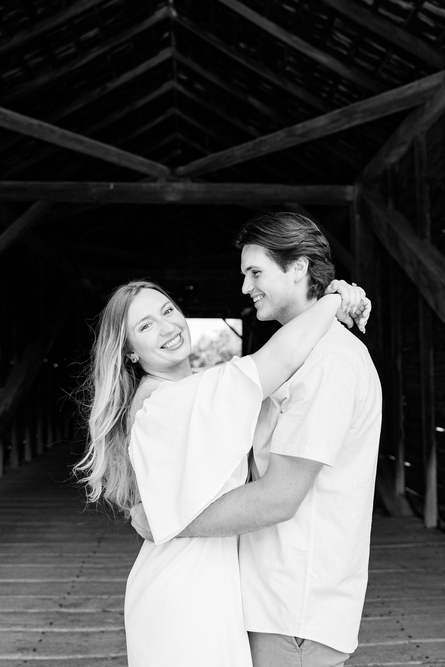Engaged couple embracing at Greenfield Village in Dearborn, MI