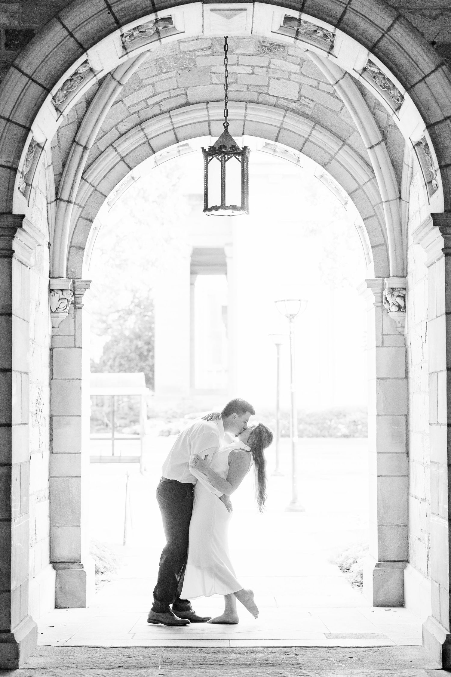 Engaged couple dipping and kissing at the UM Law Quad engagement session in Ann Arbor, MI