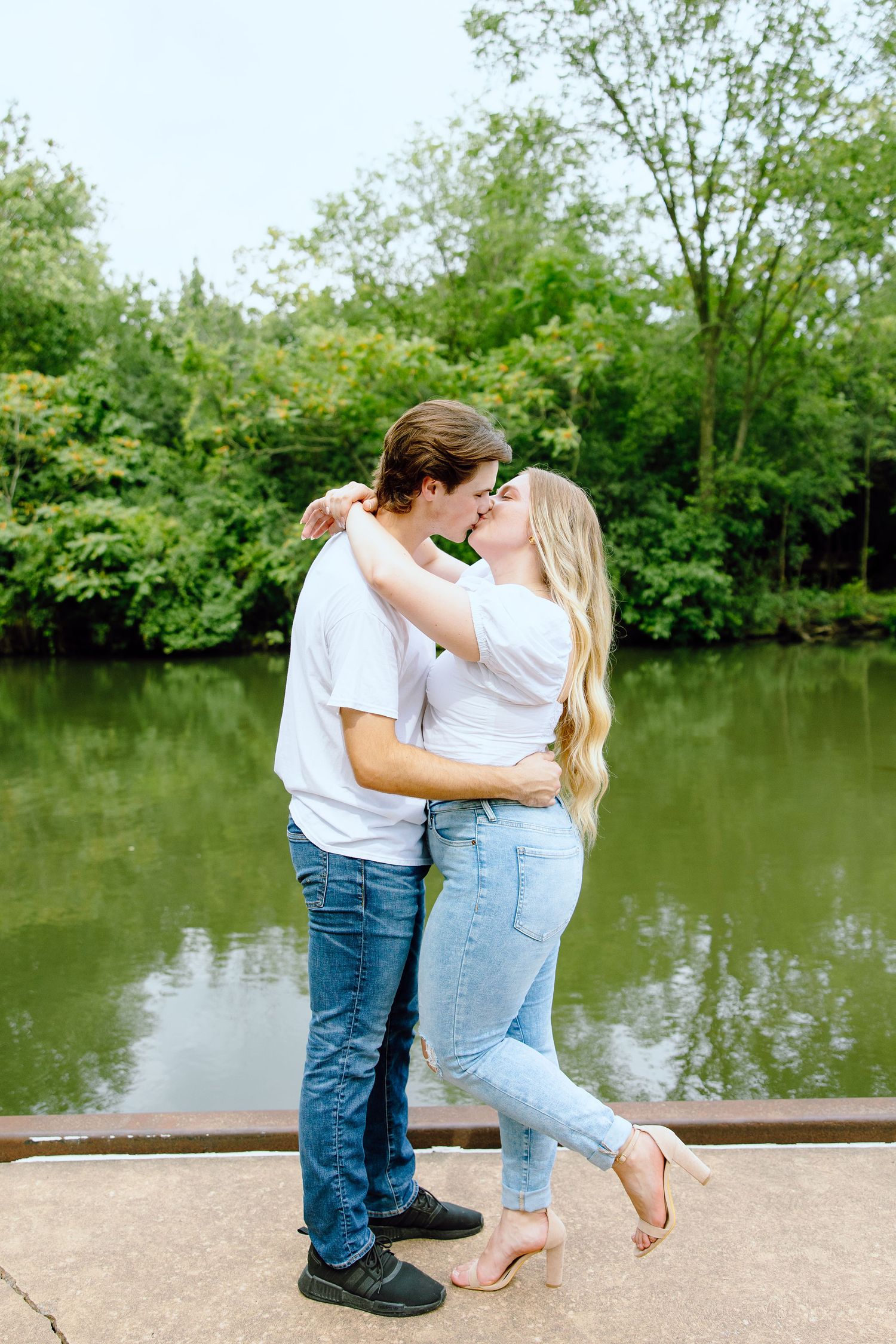 Engaged couple kissing at Greenfield Village in Dearborn, MI