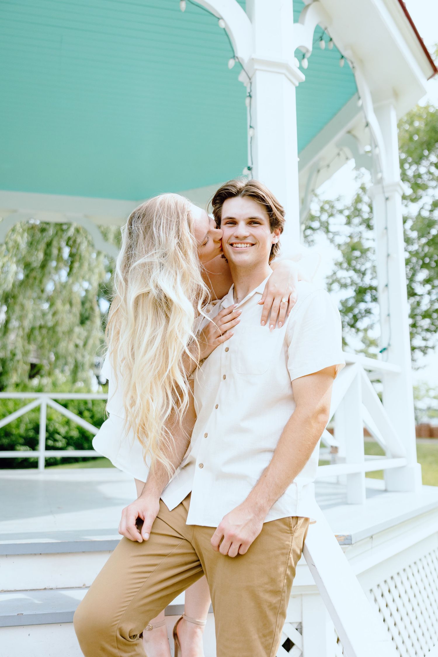 Engaged couple embracing at Greenfield Village in Dearborn, MI
