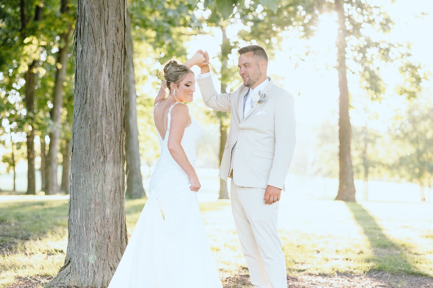 Groom twirling bride at Lapeer Country Club wedding in Michigan