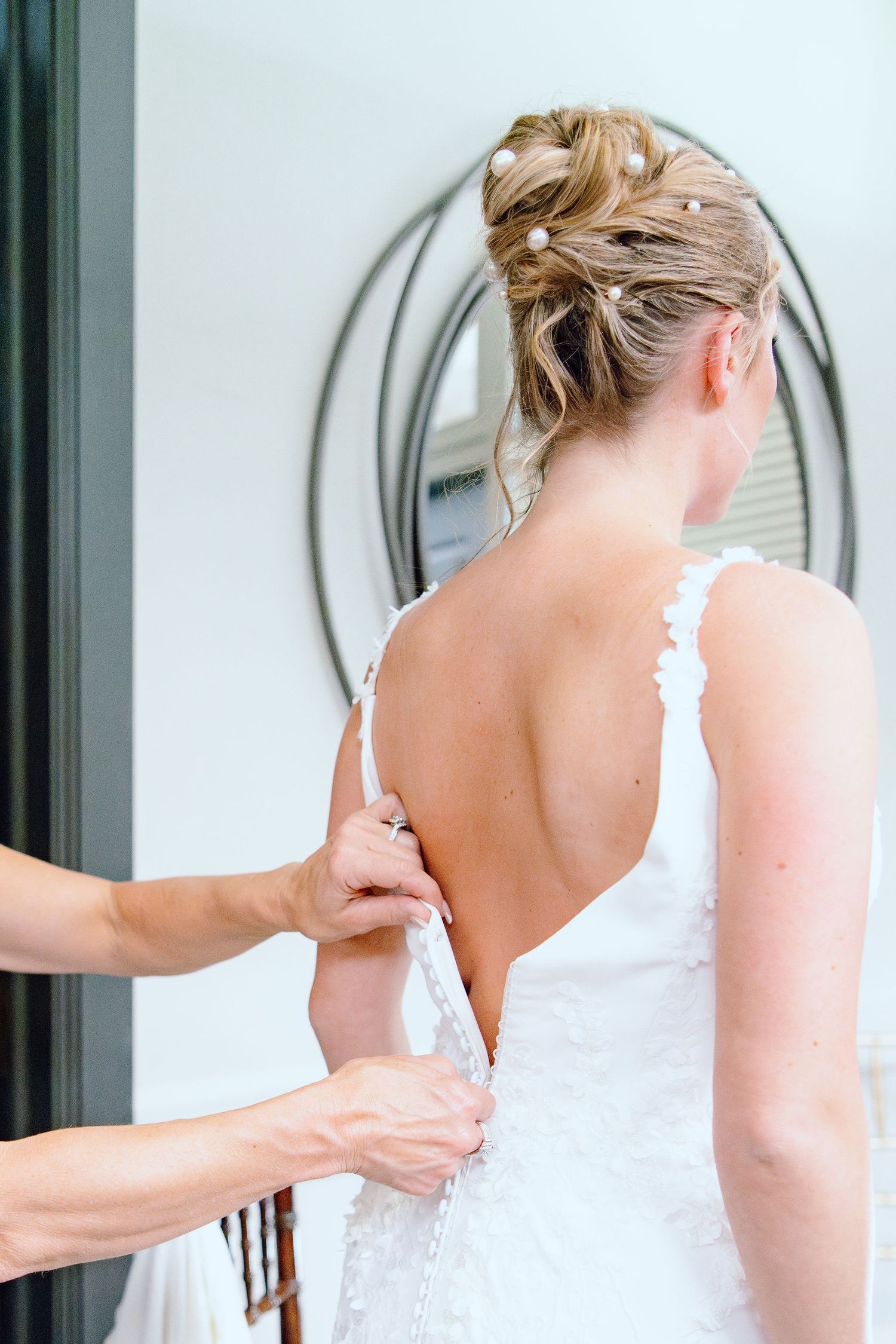 Bride getting into dress at Lapeer Country Club wedding in Michigan