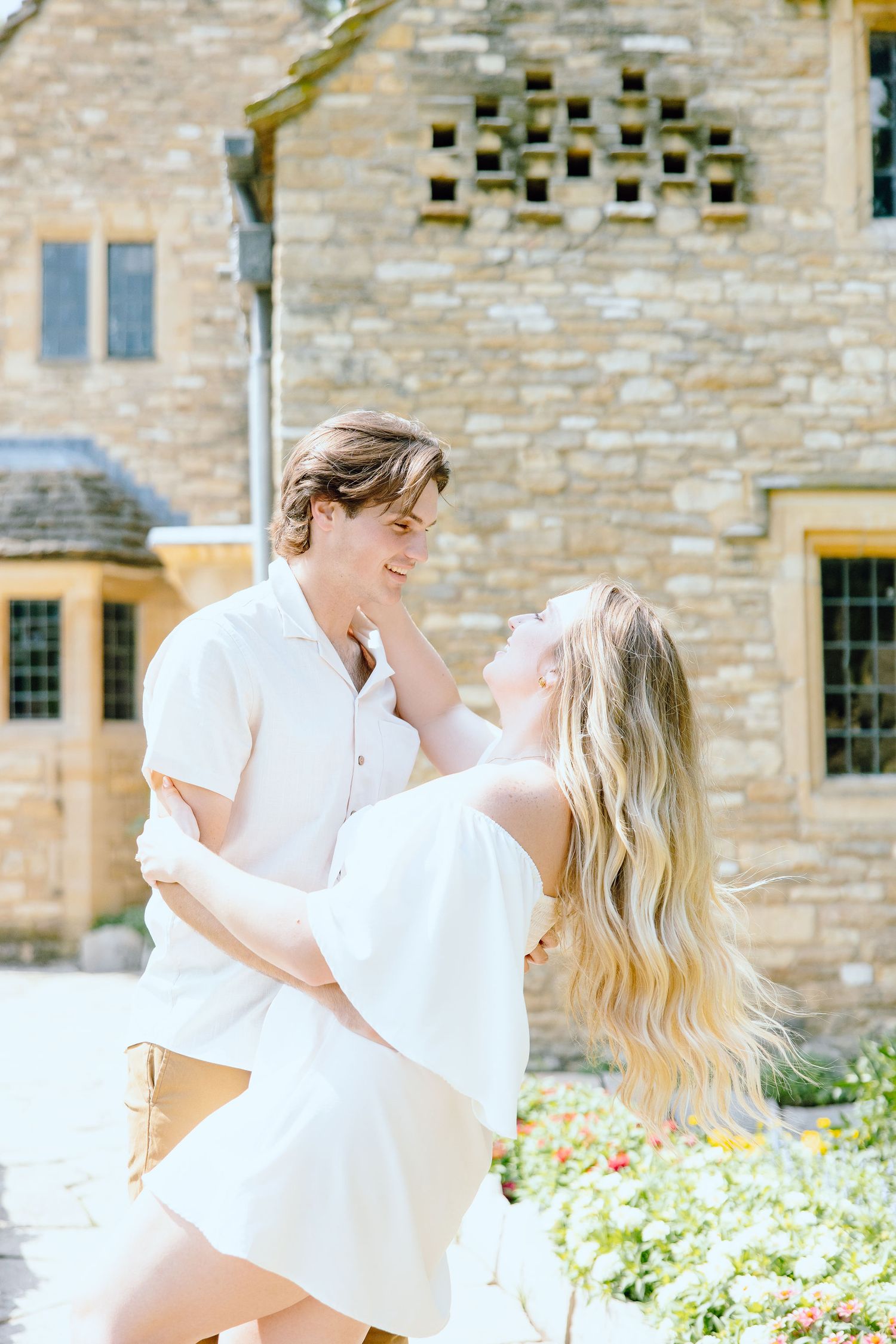 Engaged couple embracing at Greenfield Village in Dearborn, MI