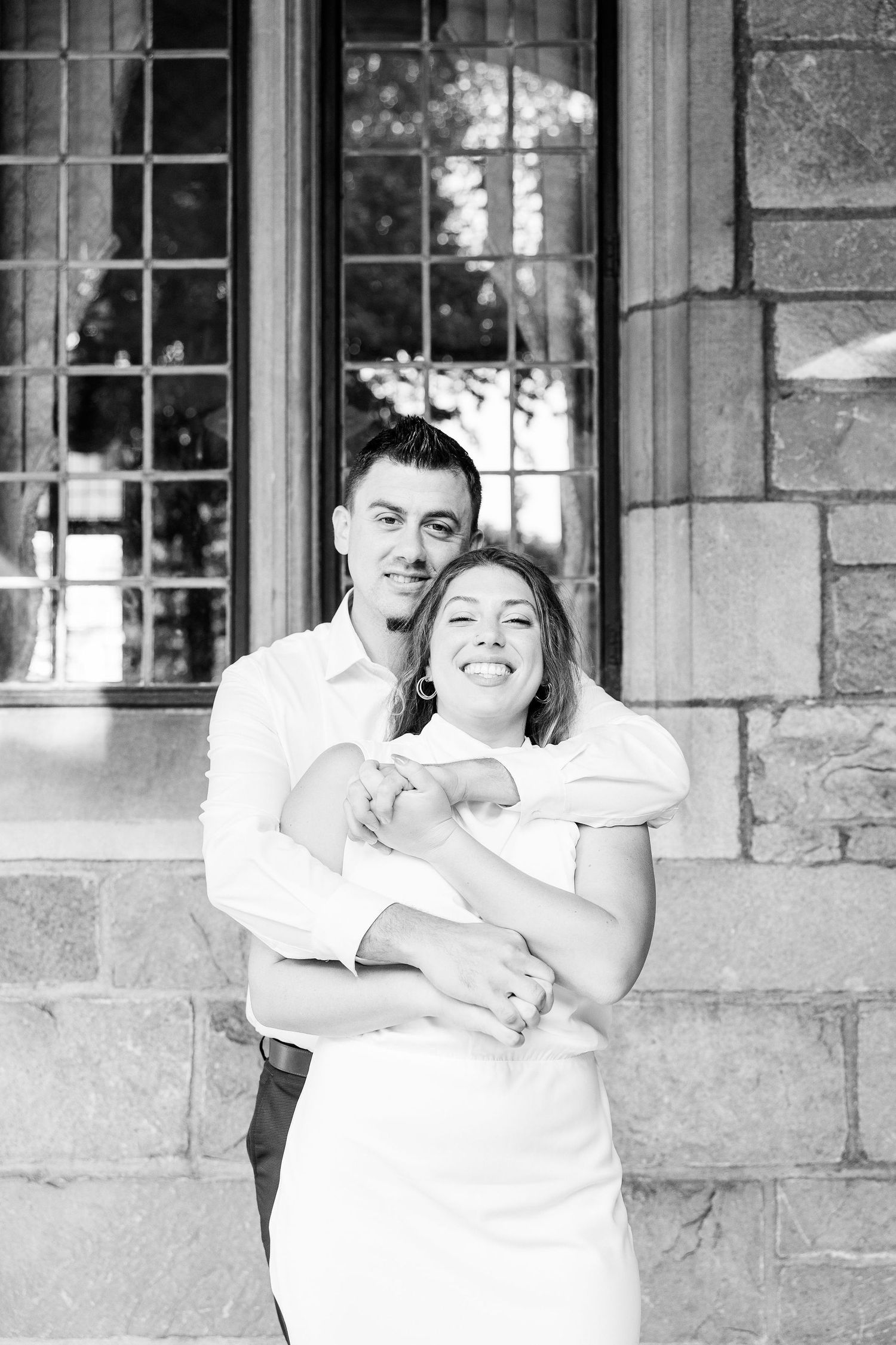 Engaged couple embracing at the University of Michigan Law Quad engagement session in Ann Arbor, MI