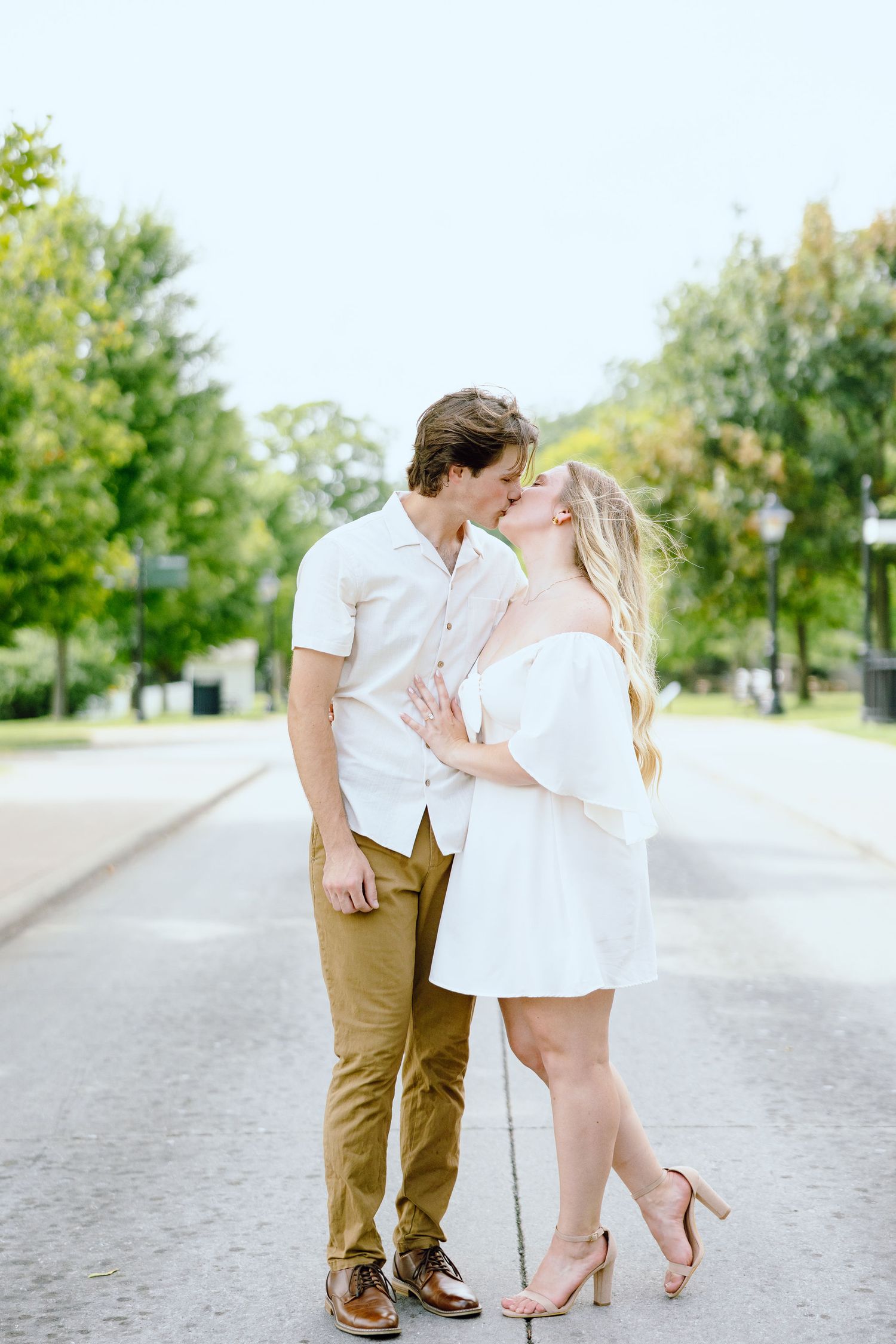 Engaged couple kissing at Greenfield Village in Dearborn, MI