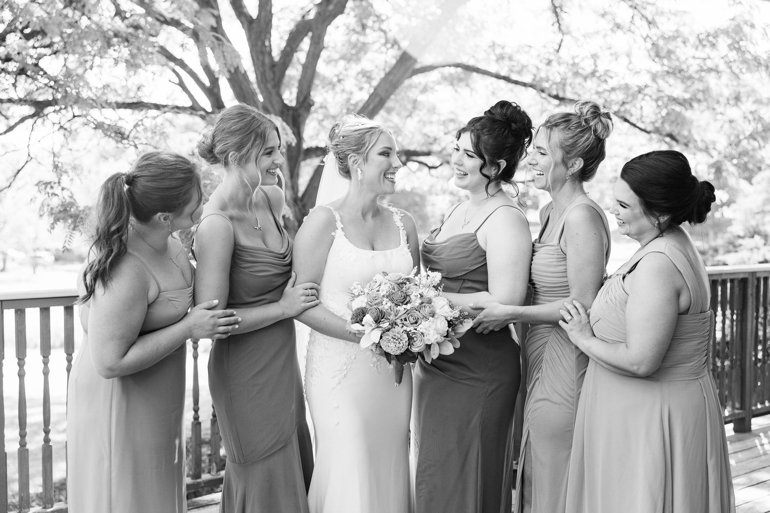 Bride and bridesmaids standing in a line at Lapeer Country Club wedding in Michigan