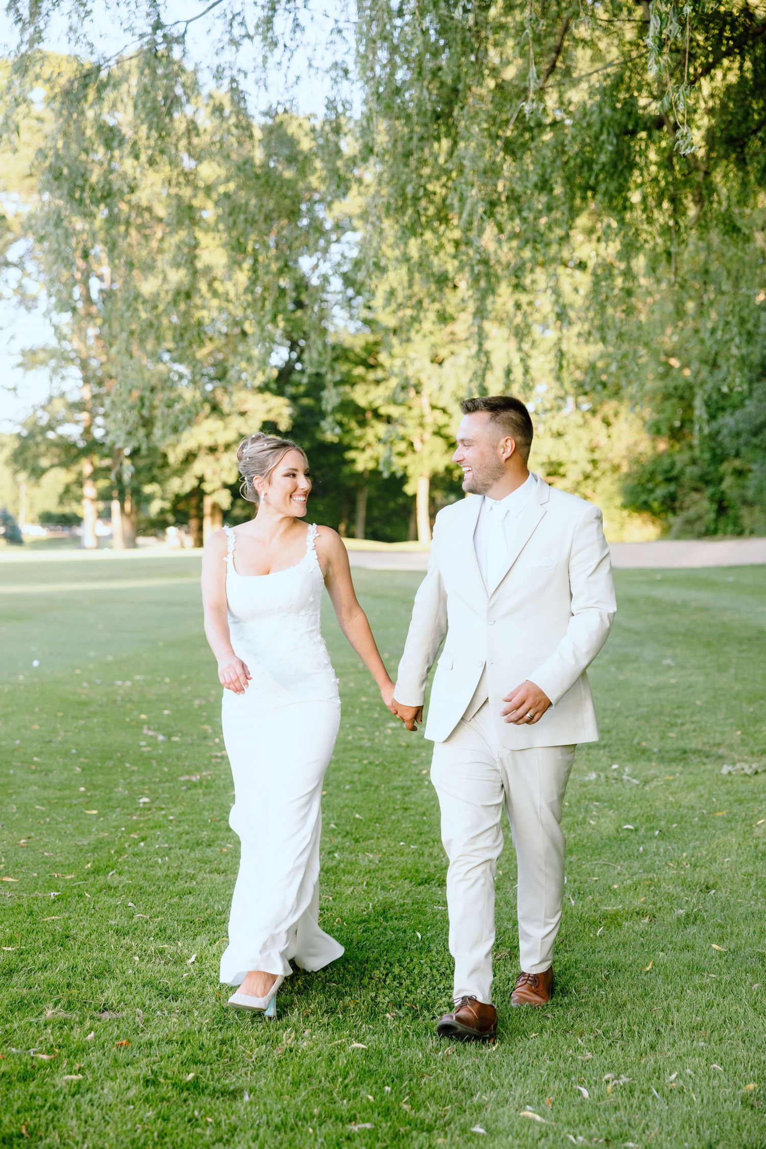 Married couple holding hands on golf course at Lapeer Country Club, Michigan
