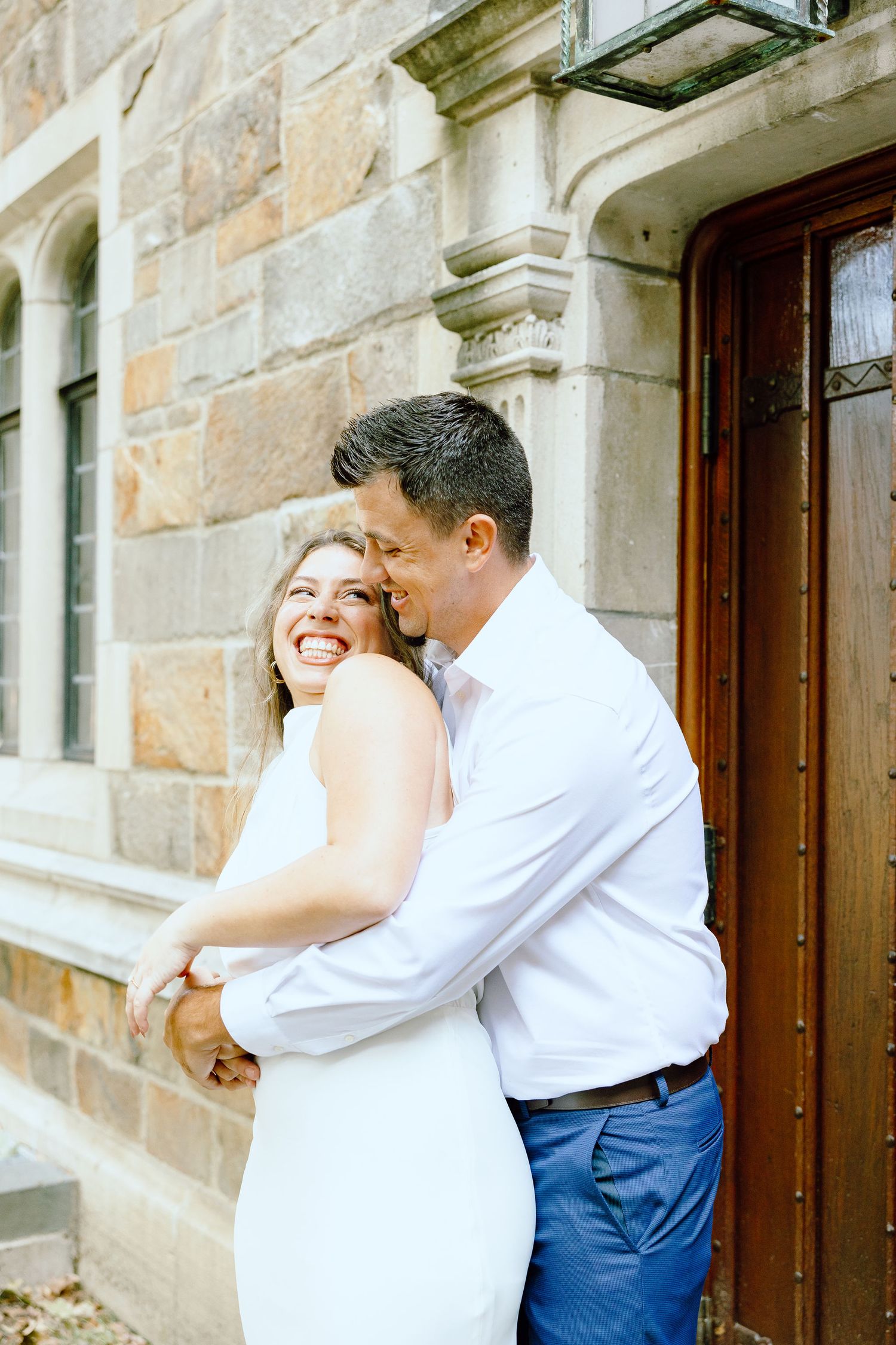 Engaged couple embracing at the University of Michigan Law Quad engagement session in Ann Arbor, MI
