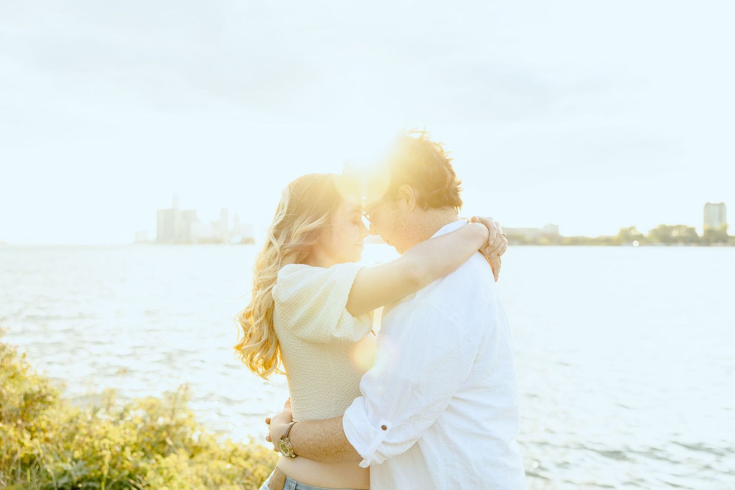 Engaged couple embracing at Belle Isle summer engagement session in Detroit, MI