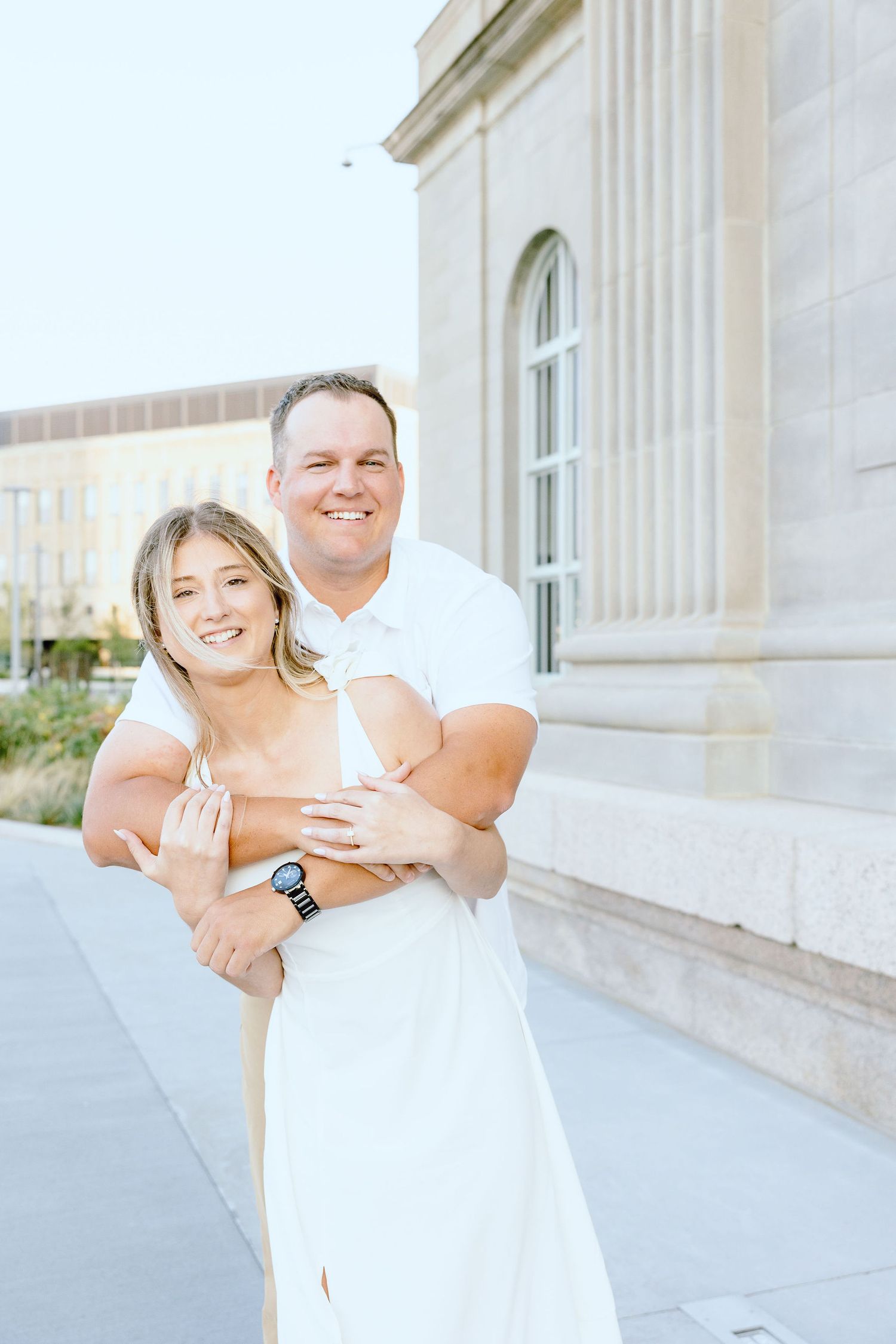 Engaged couple embracing at Michigan Central Station summer engagement session in Detroit, MI