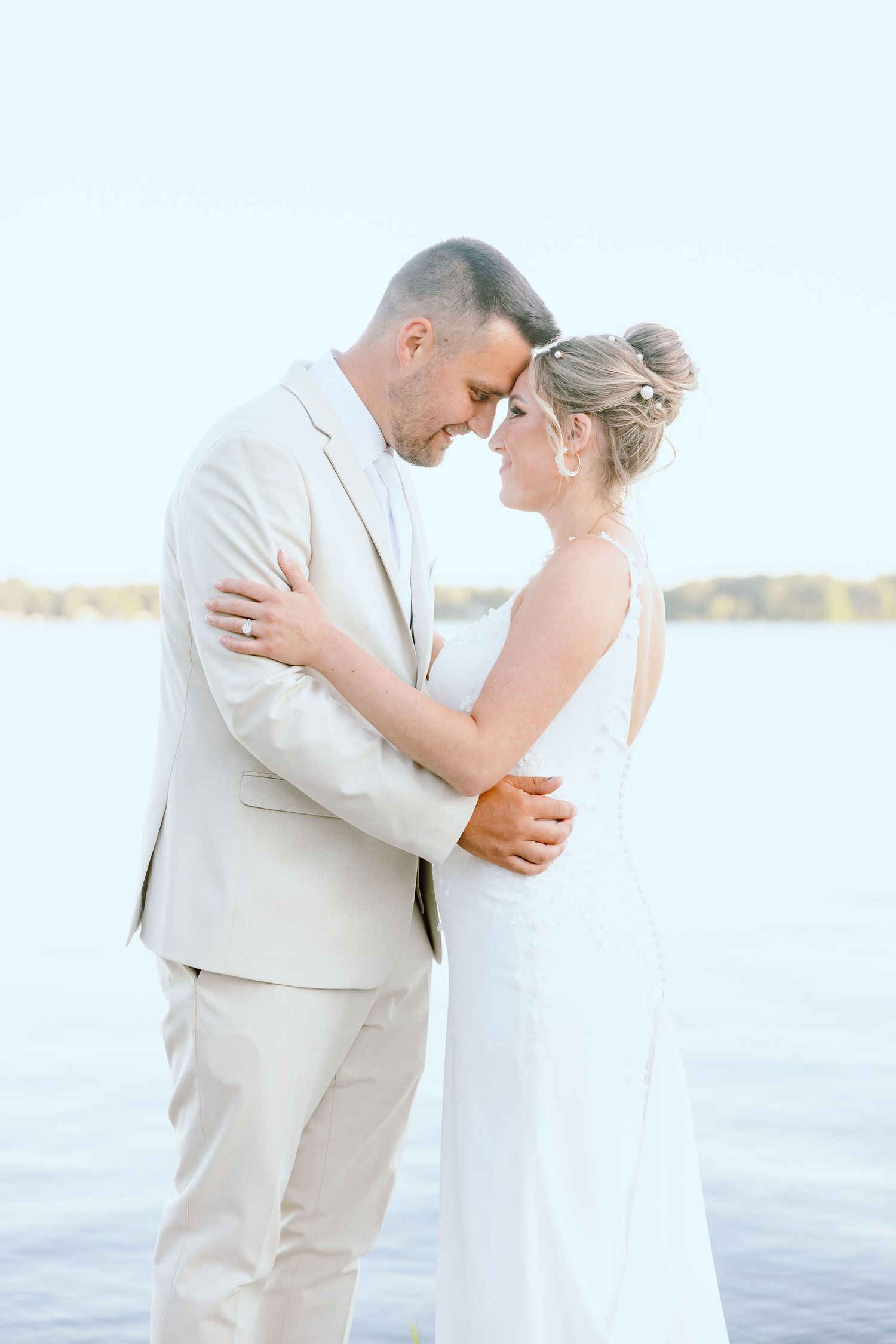 Married couple dipping on lake during golden hour at Lapeer Country Club wedding in Michigan