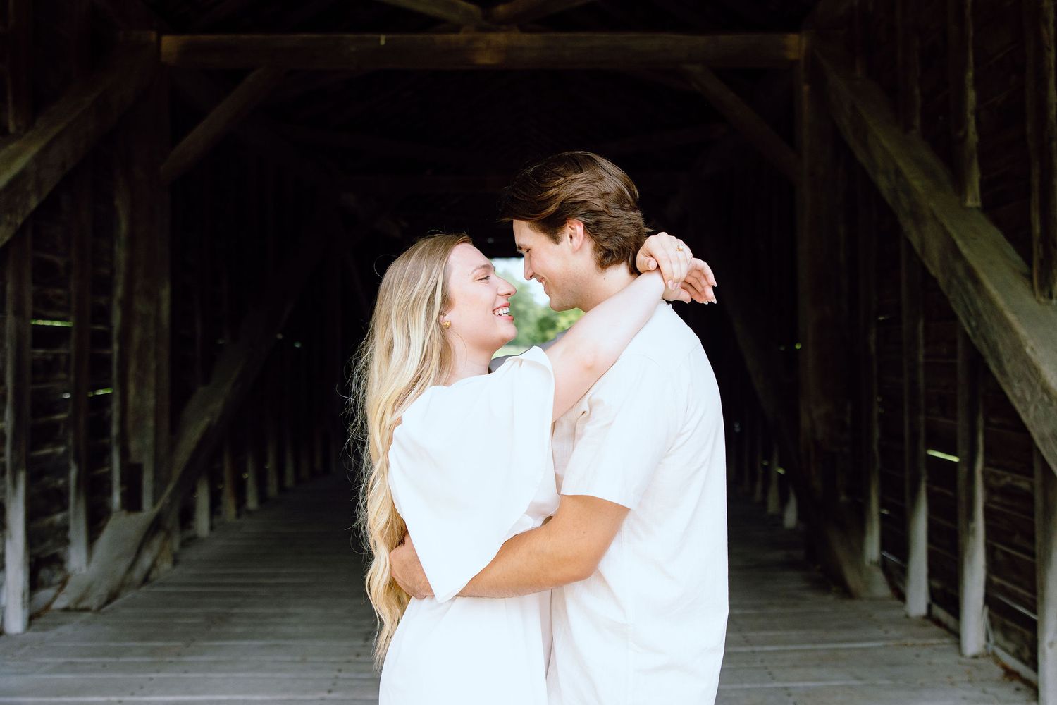 Engaged couple embracing at Greenfield Village in Dearborn, MI