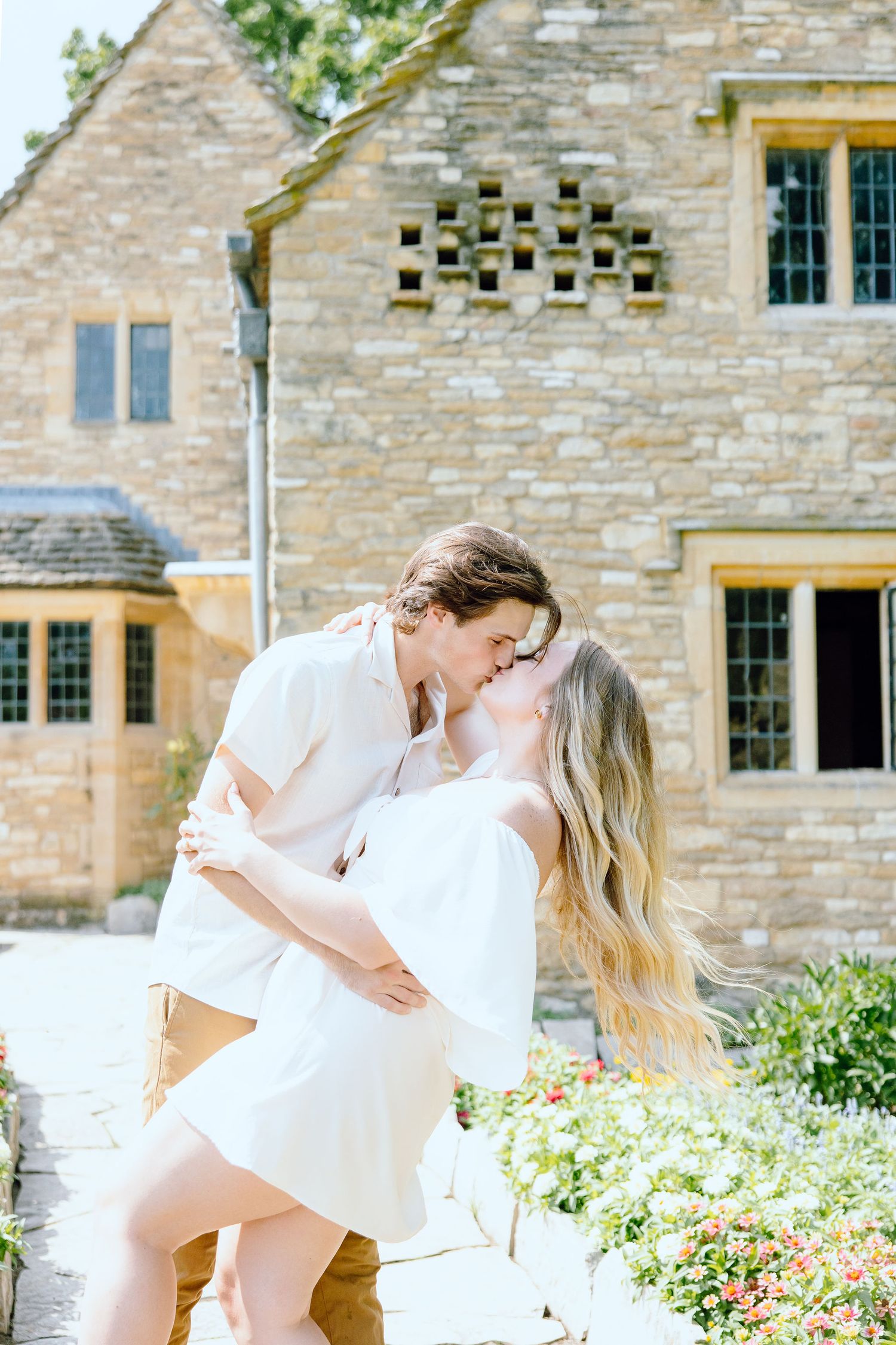Engaged couple kissing at Greenfield Village in Dearborn, MI