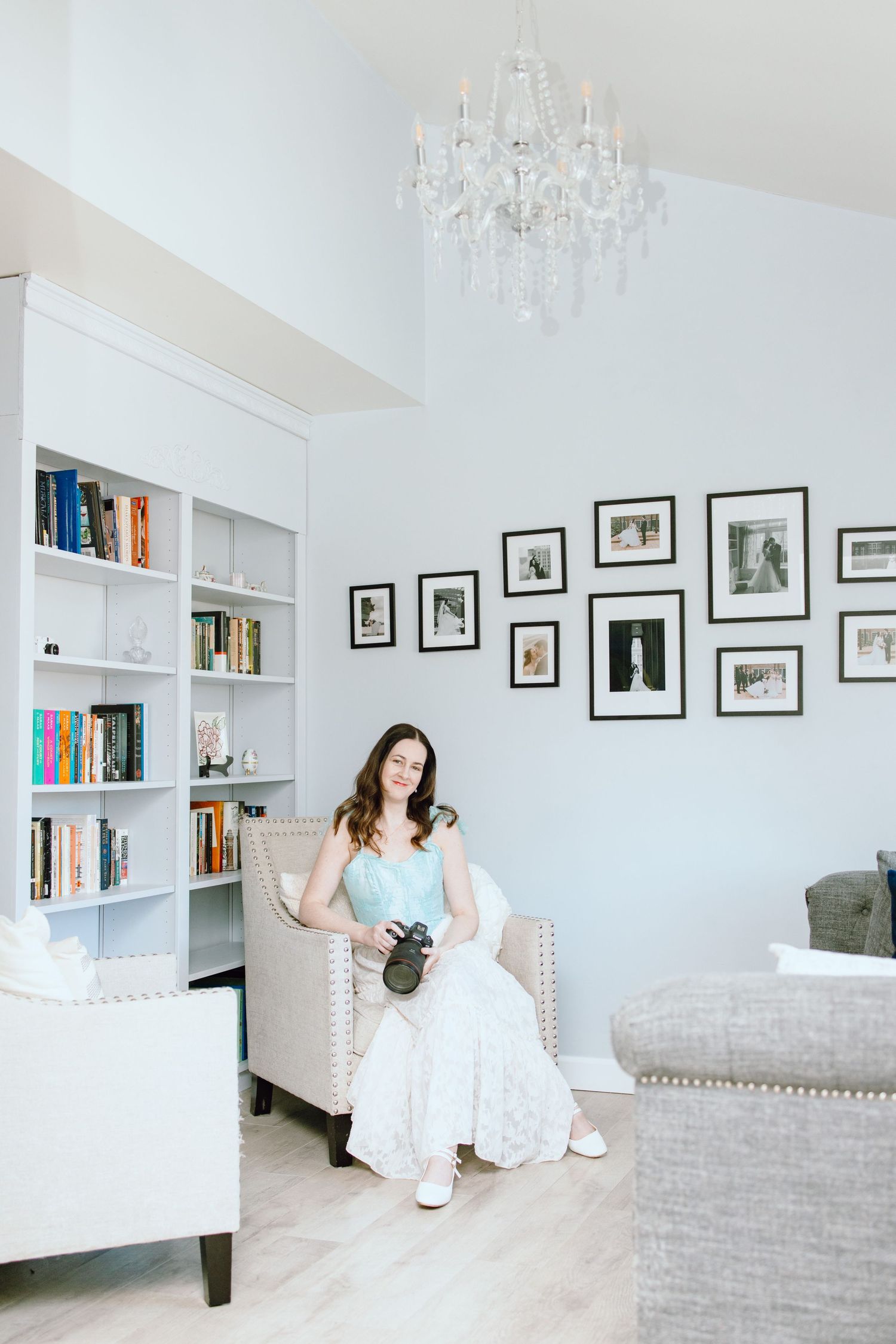 Owner of Perri Foster Photography, LLC sitting in living room with camera