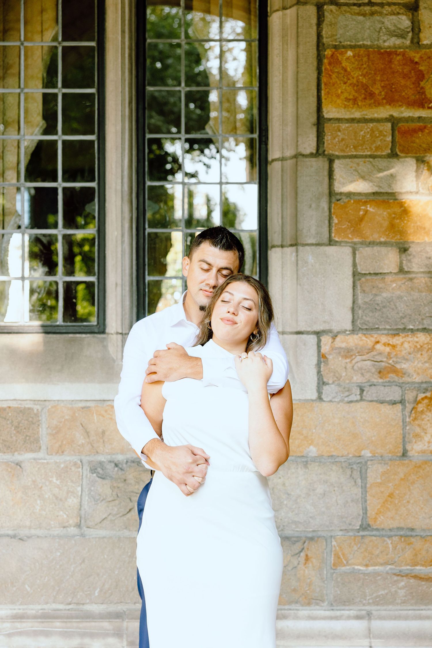 Engaged couple embracing at the University of Michigan Law Quad engagement session in Ann Arbor, MI