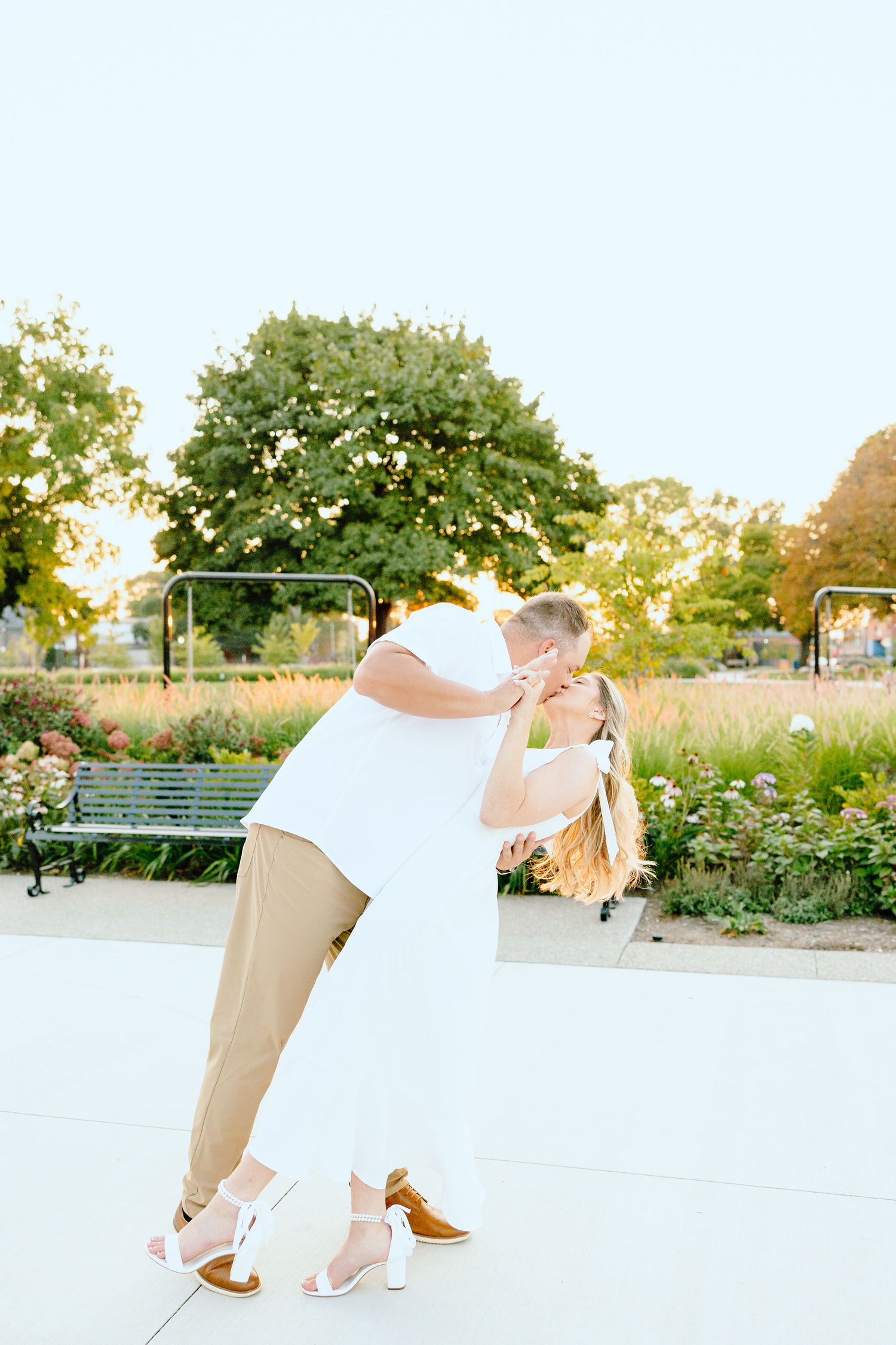 Engaged couple dipping and kissing at Michigan Central Station summer engagement session in Detroit, MI