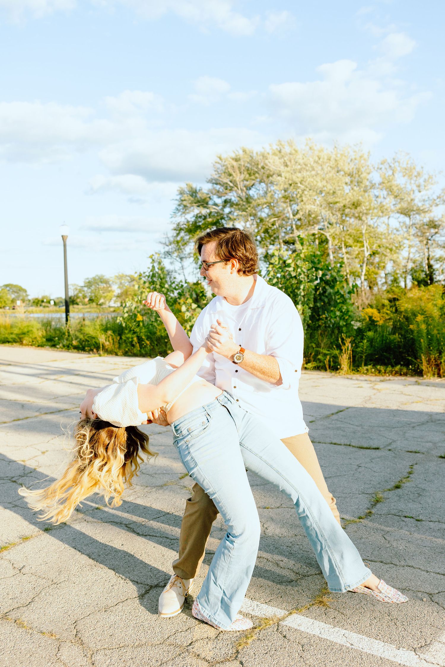 Engaged couple swing dancing at Belle Isle summer engagement session in Detroit, MI