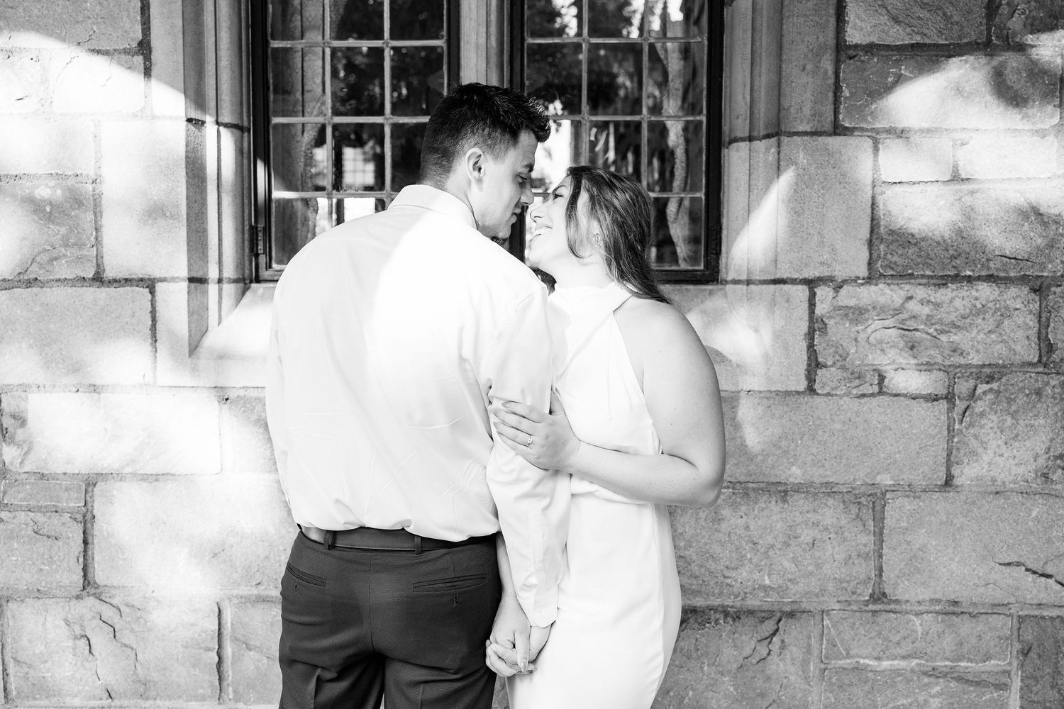 Engaged couple embracing at the University of Michigan Law Quad engagement session in Ann Arbor, MI