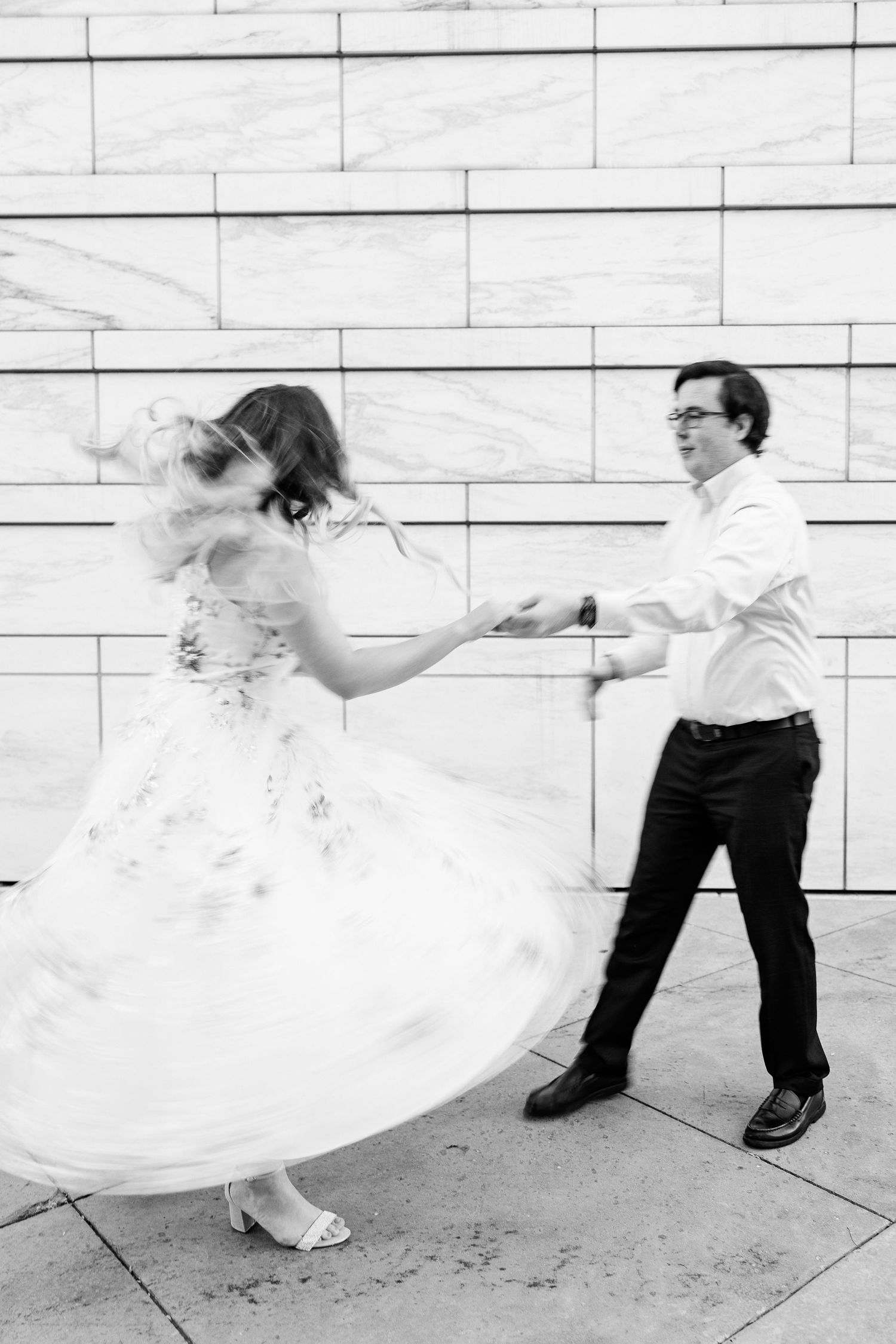Engaged couple swing dancing at Detroit Institute of Arts engagement session in Detroit, MI