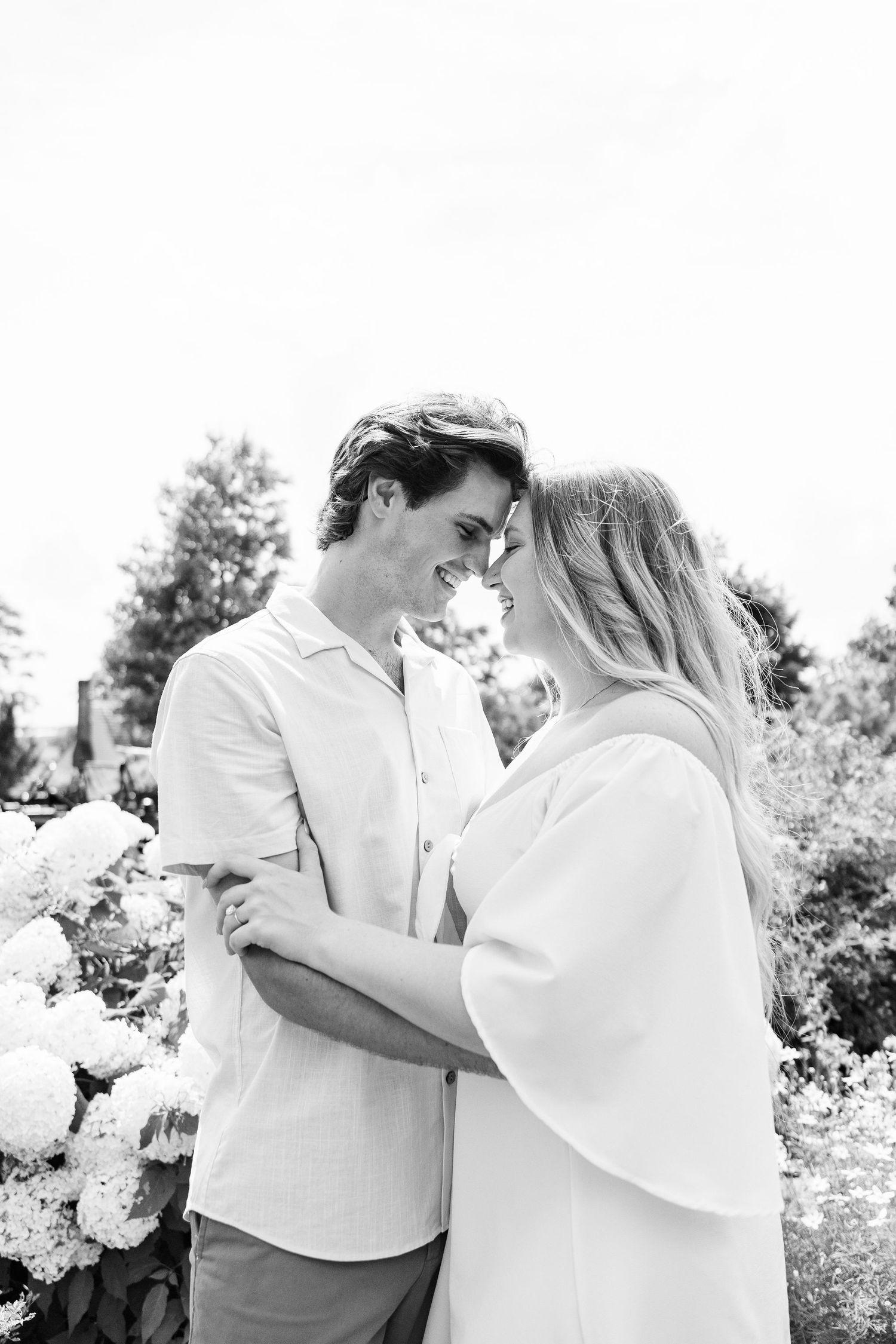 Engaged couple embracing at Greenfield Village in Dearborn, MI