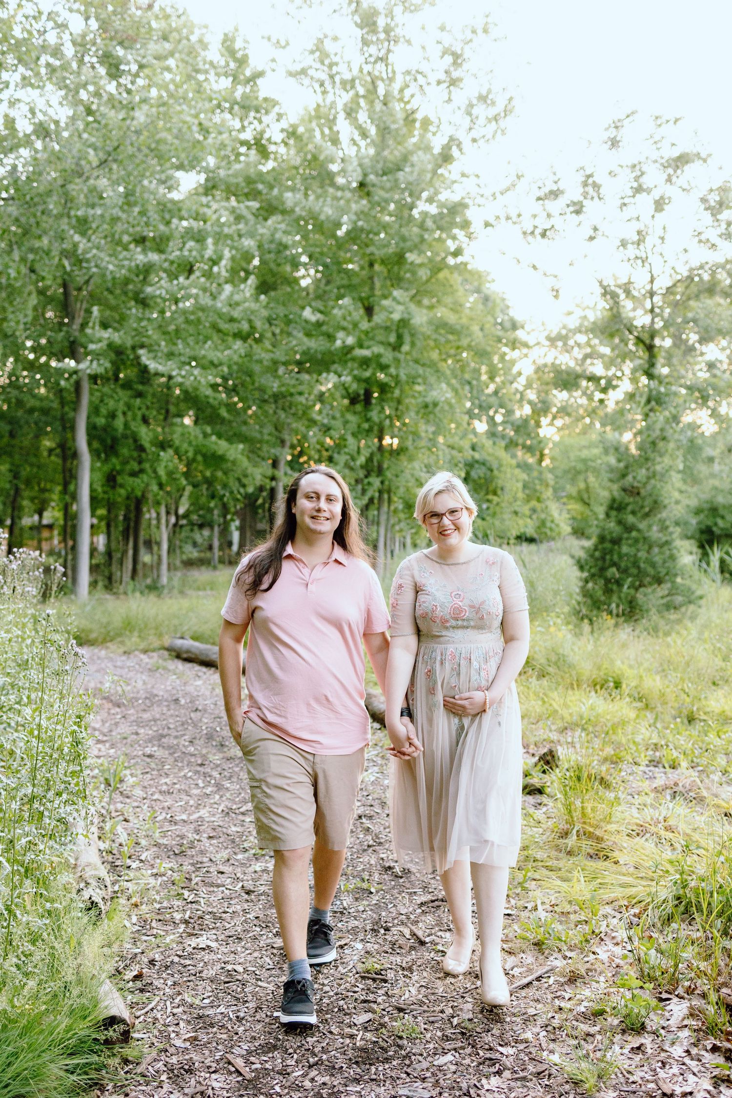 Pregnant couple walking in Beverly Hills Village Park, MI