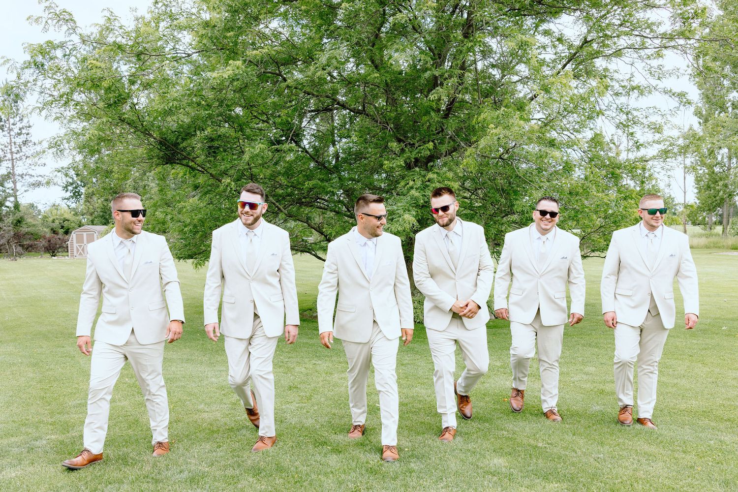 Groomsmen walking at Lapeer Country Club wedding in Michigan