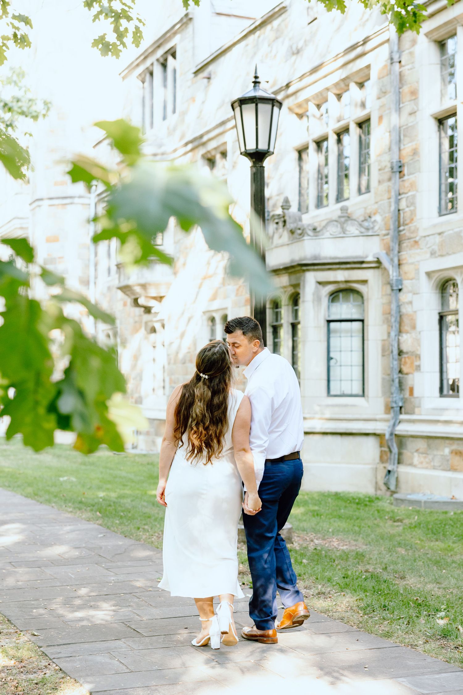 Engaged couple kissing at the University of Michigan Law Quad engagement session in Ann Arbor, MI