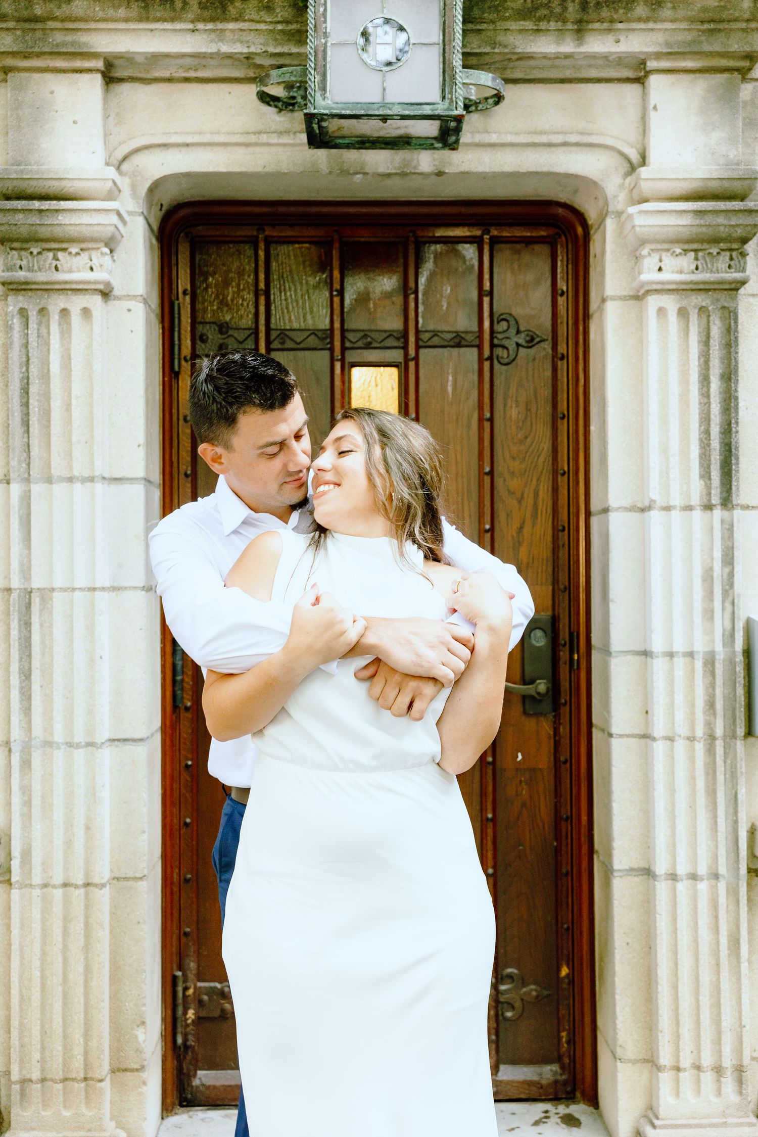 Engaged couple embracing at the University of Michigan Law Quad engagement session in Ann Arbor, MI