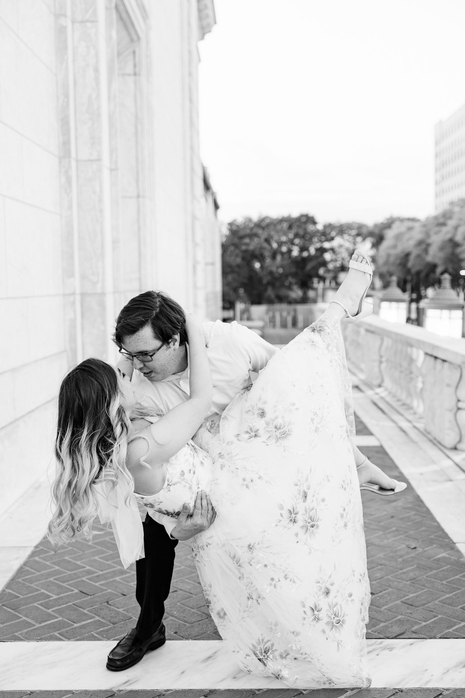 Man lifting woman at Detroit Institute of Arts engagement session in Detroit, MI