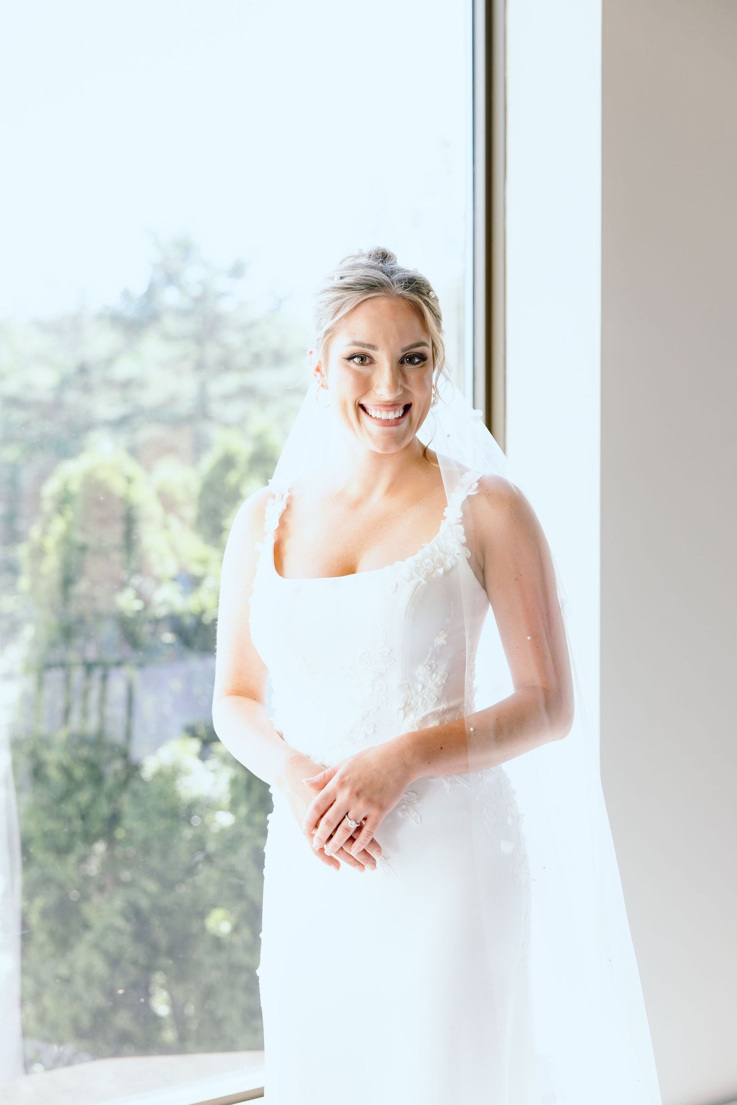 Bride portrait in front of window at Lapeer Country Club wedding in Michigan
