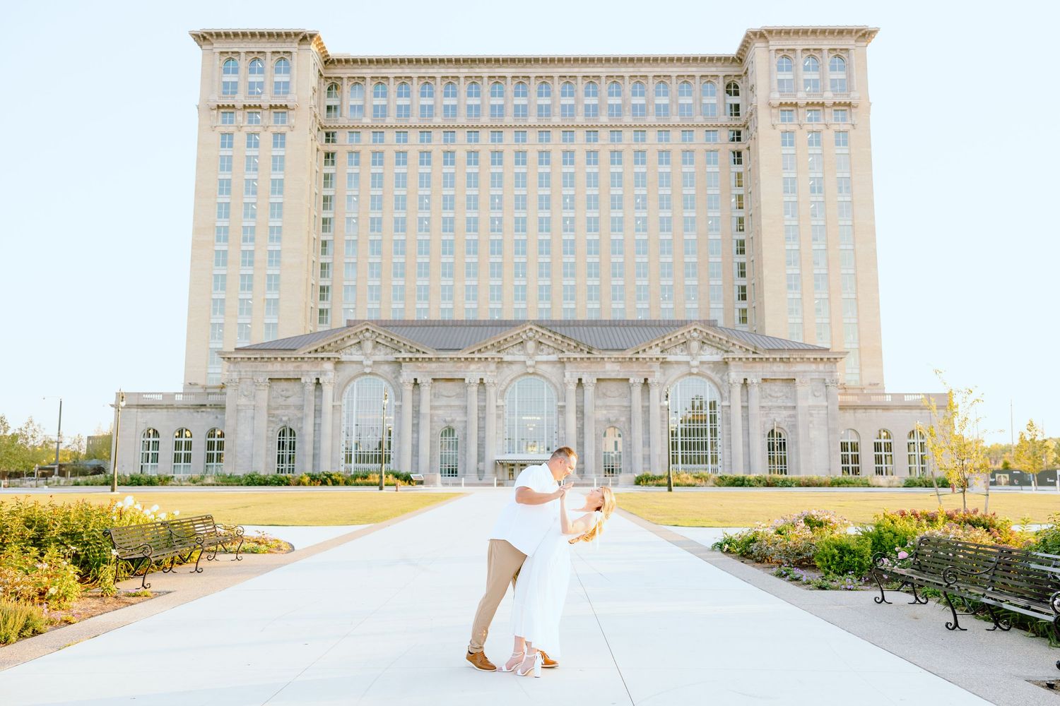 Engaged couple dipping at Michigan Central Station summer engagement session in Detroit, MI