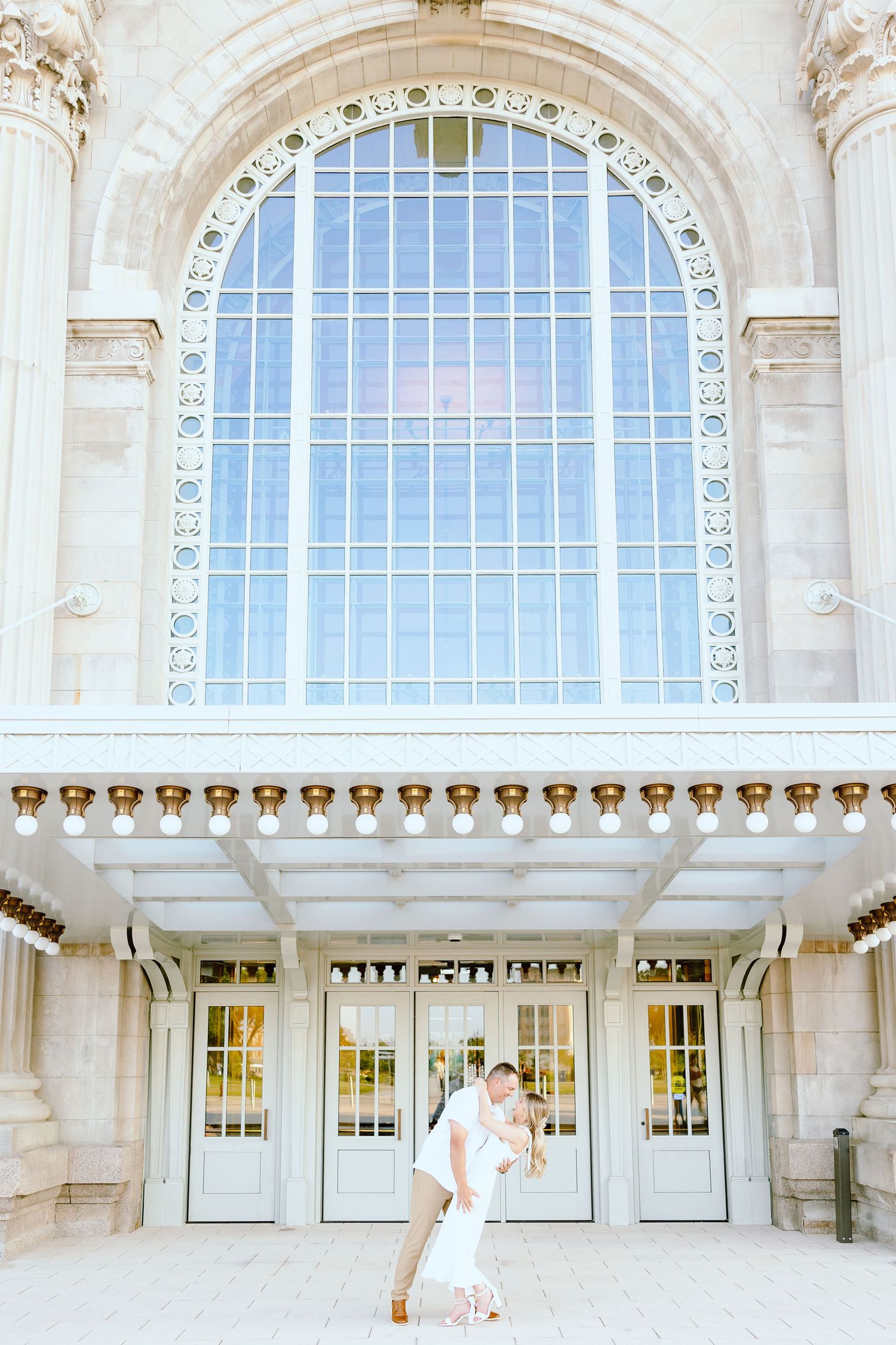 Engaged couple dipping at Michigan Central Station summer engagement session in Detroit, MI