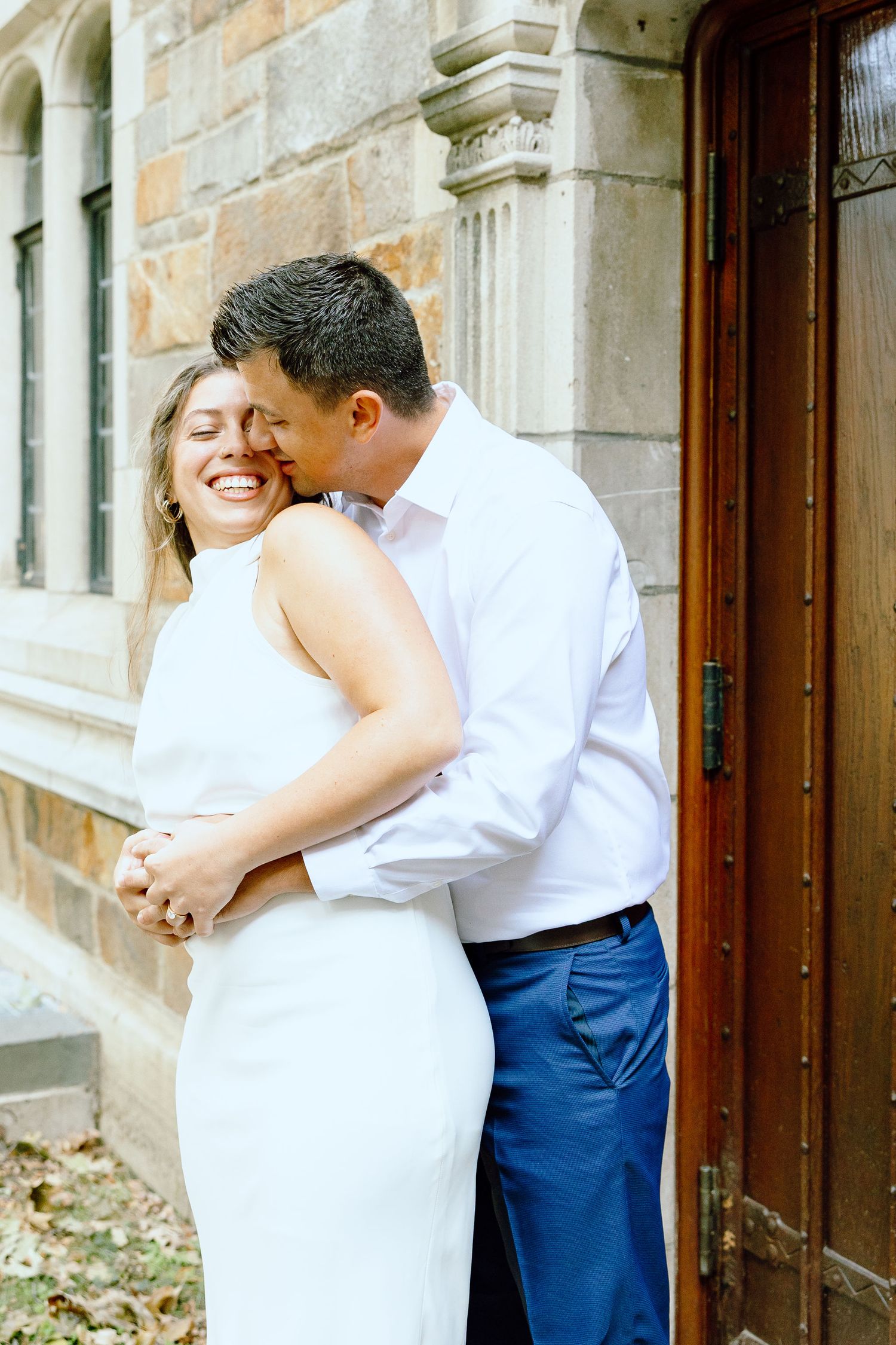 Engaged couple embracing at the University of Michigan Law Quad engagement session in Ann Arbor, MI