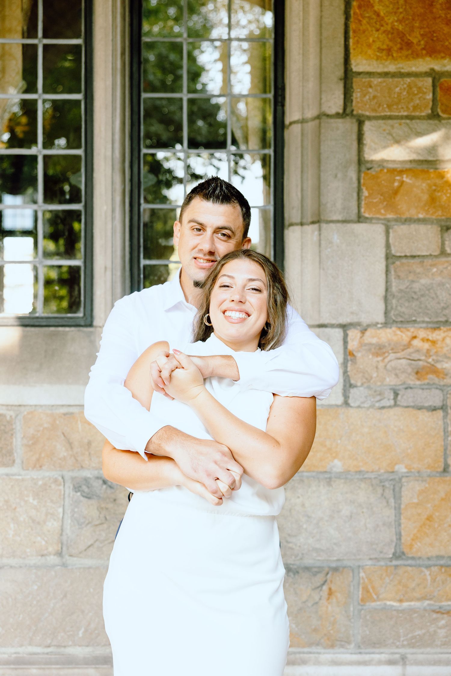 Engaged couple embracing at the University of Michigan Law Quad engagement session in Ann Arbor, MI