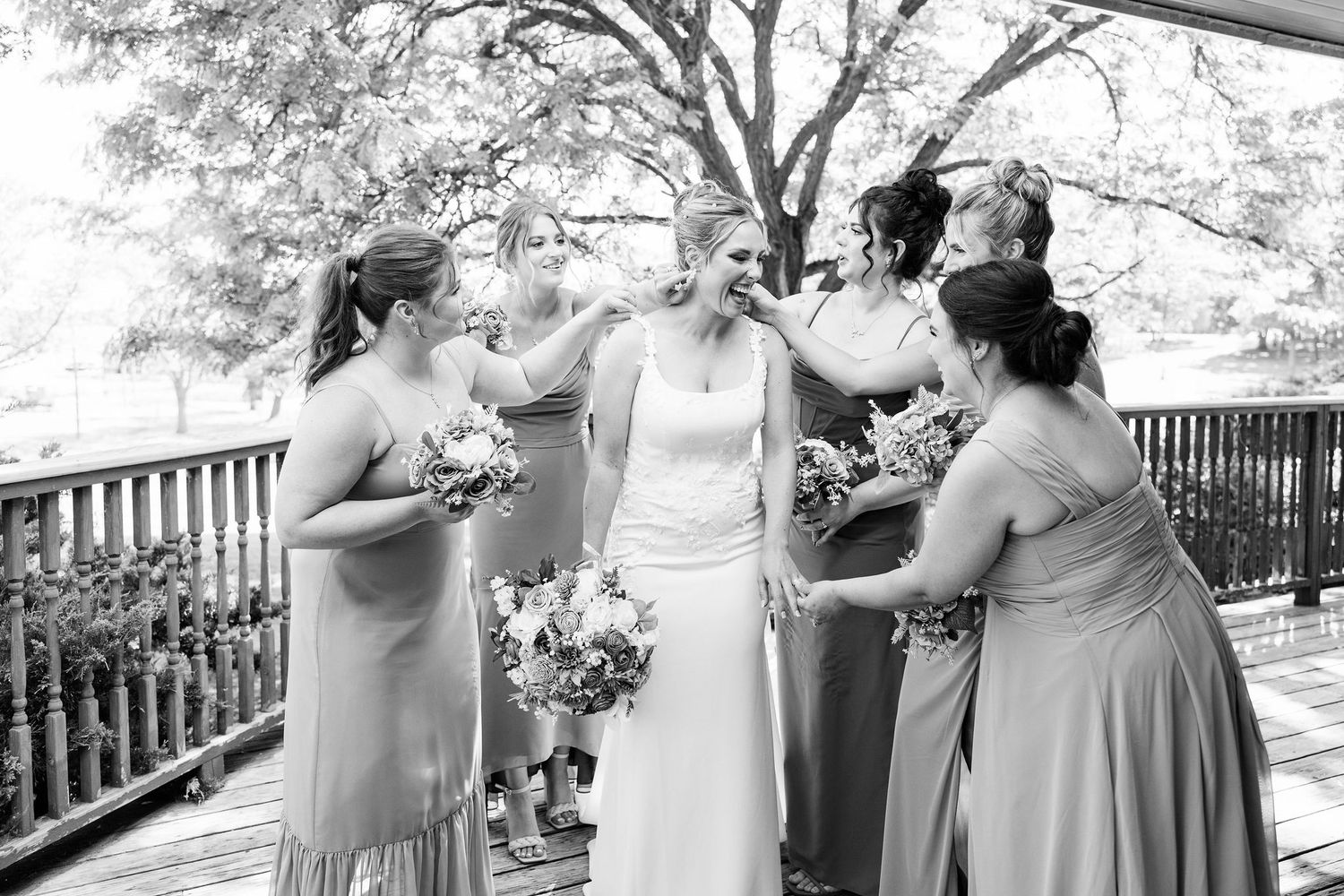 Bride and bridesmaids standing in a line at Lapeer Country Club wedding in Michigan