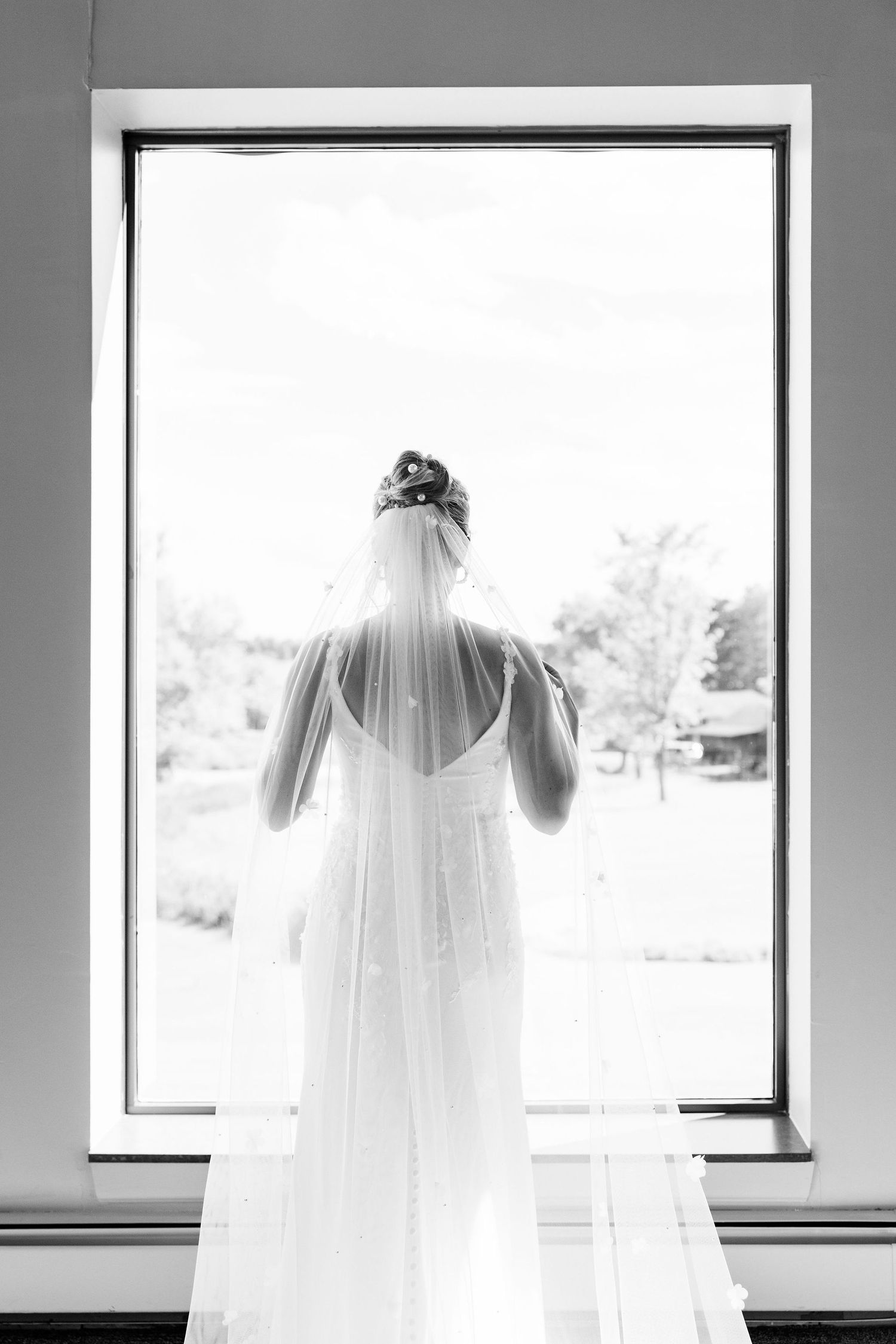 Bride portrait in front of window at Lapeer Country Club wedding in Michigan