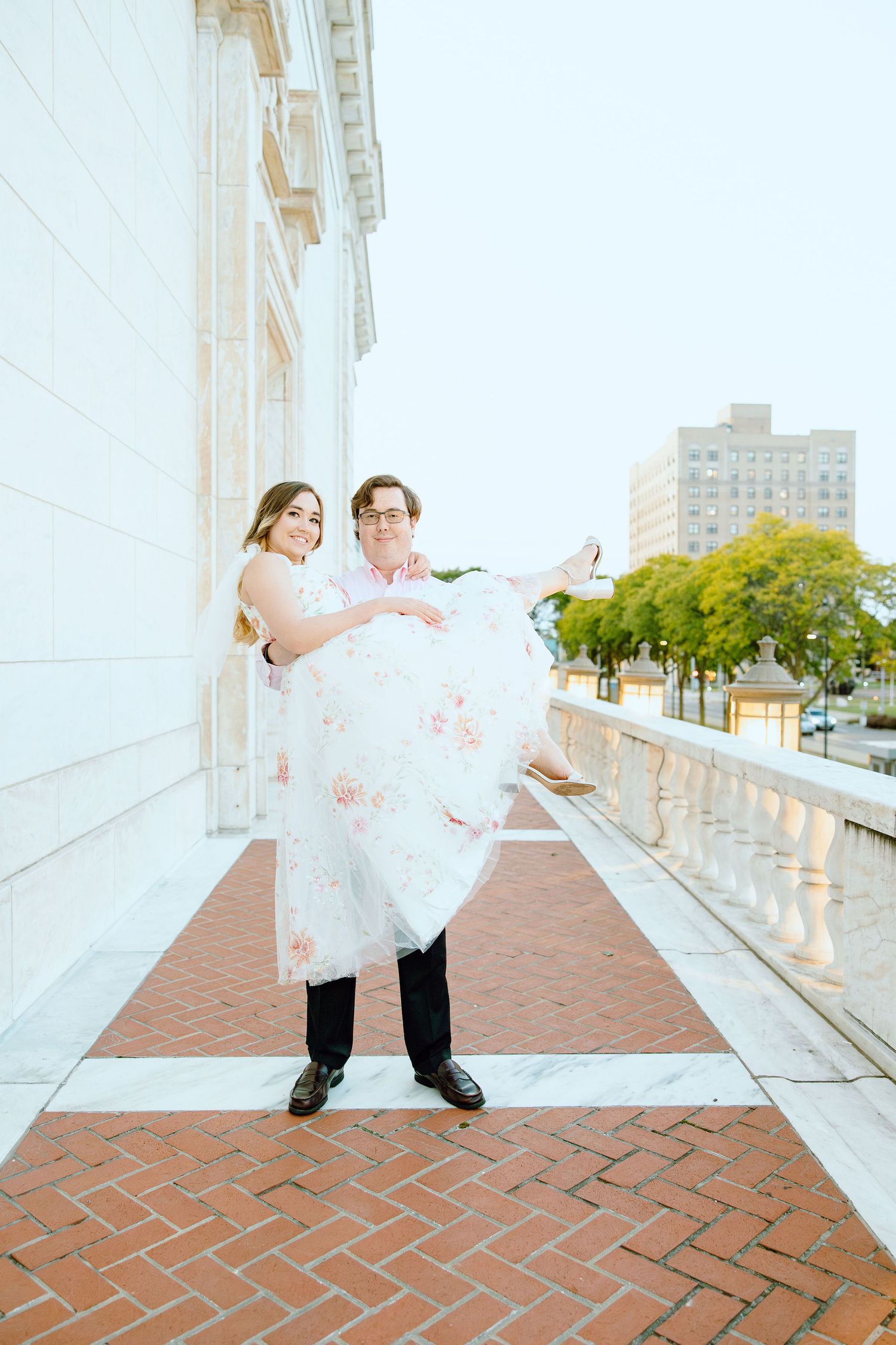 Man lifting woman at Detroit Institute of Arts engagement session in Detroit, MI