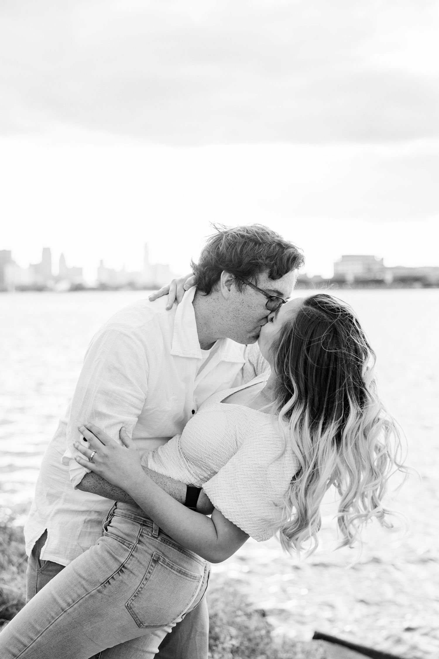 Engaged couple dipping and kissing at Belle Isle summer engagement session in Detroit, MI