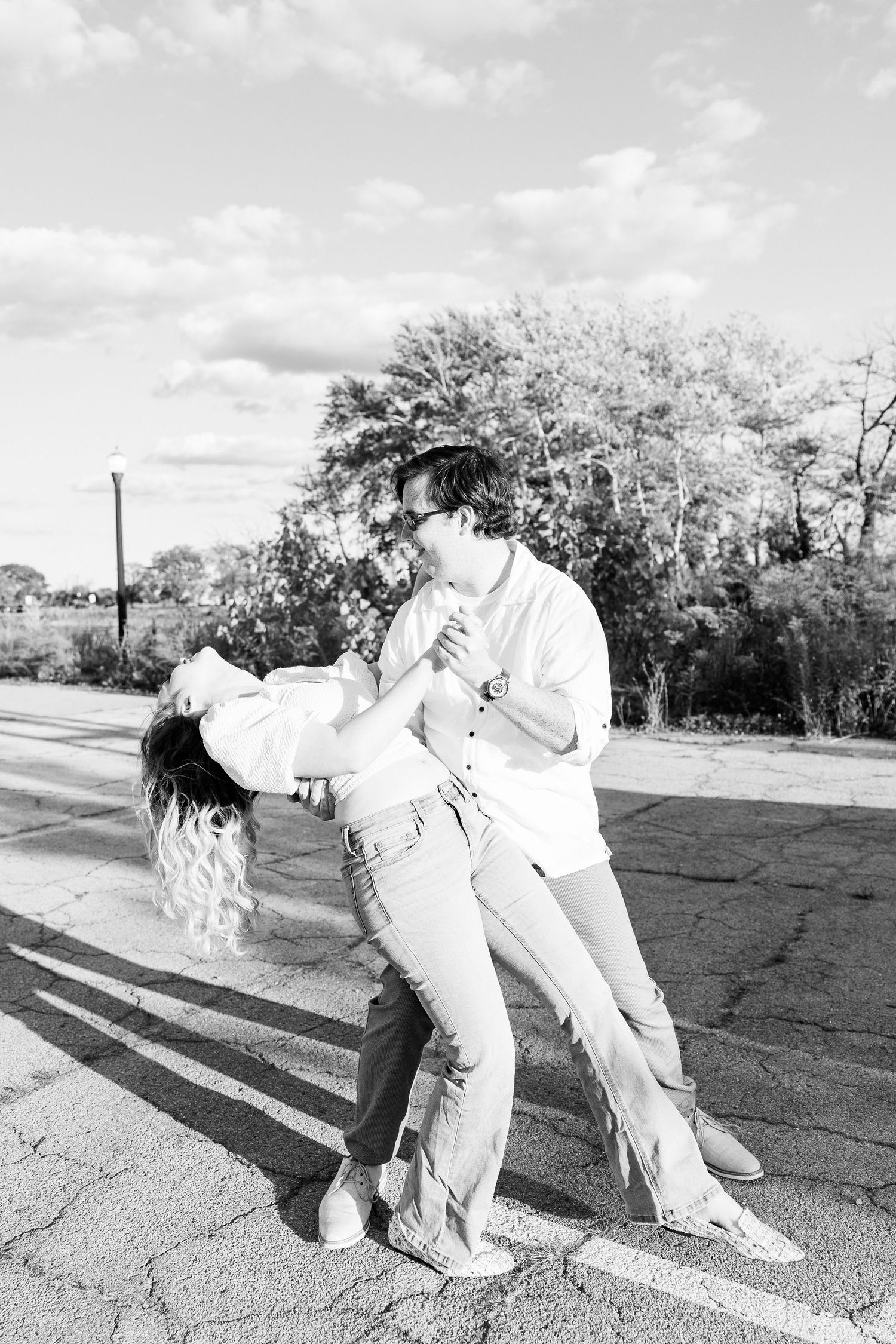 Engaged couple swing dancing at Belle Isle summer engagement session in Detroit, MI