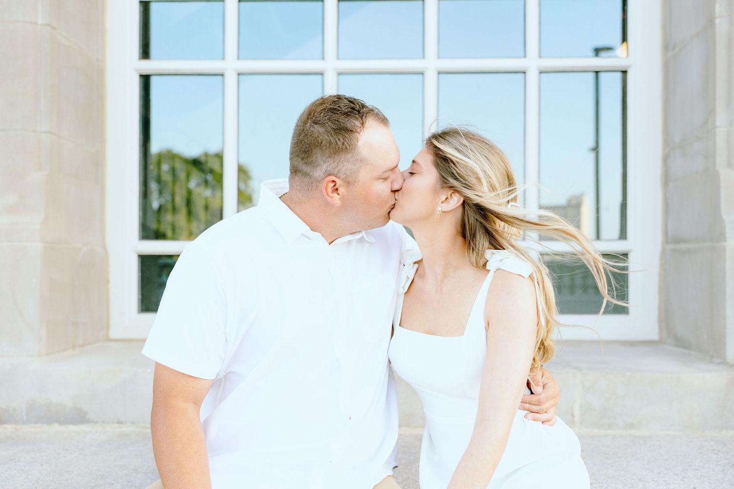 Engaged couple kissing at Michigan Central Station in Detroit, MI