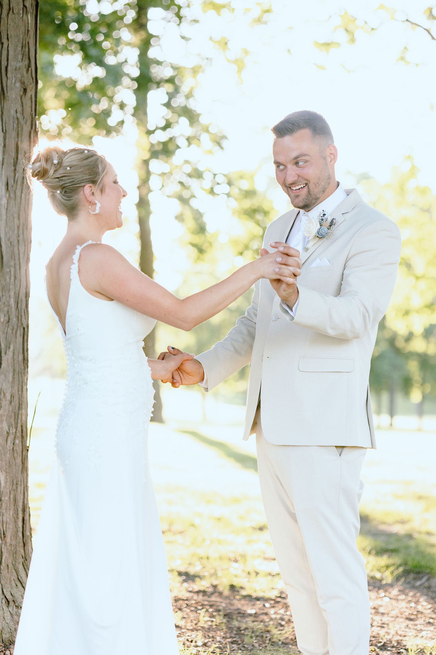 Married couple embracing during golden hour at Lapeer Country Club forest wedding in Michigan
