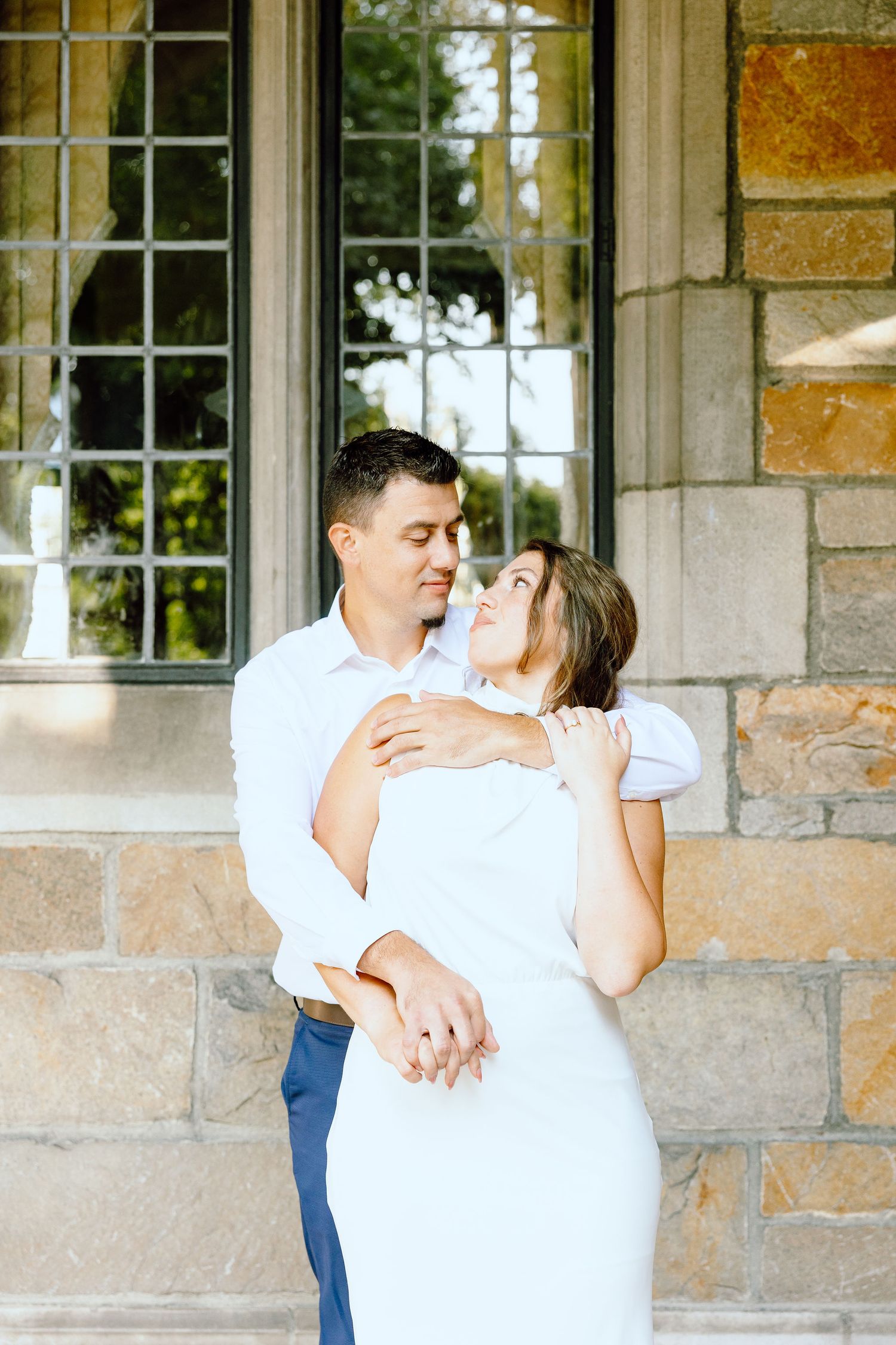Engaged couple embracing at the University of Michigan Law Quad engagement session in Ann Arbor, MI