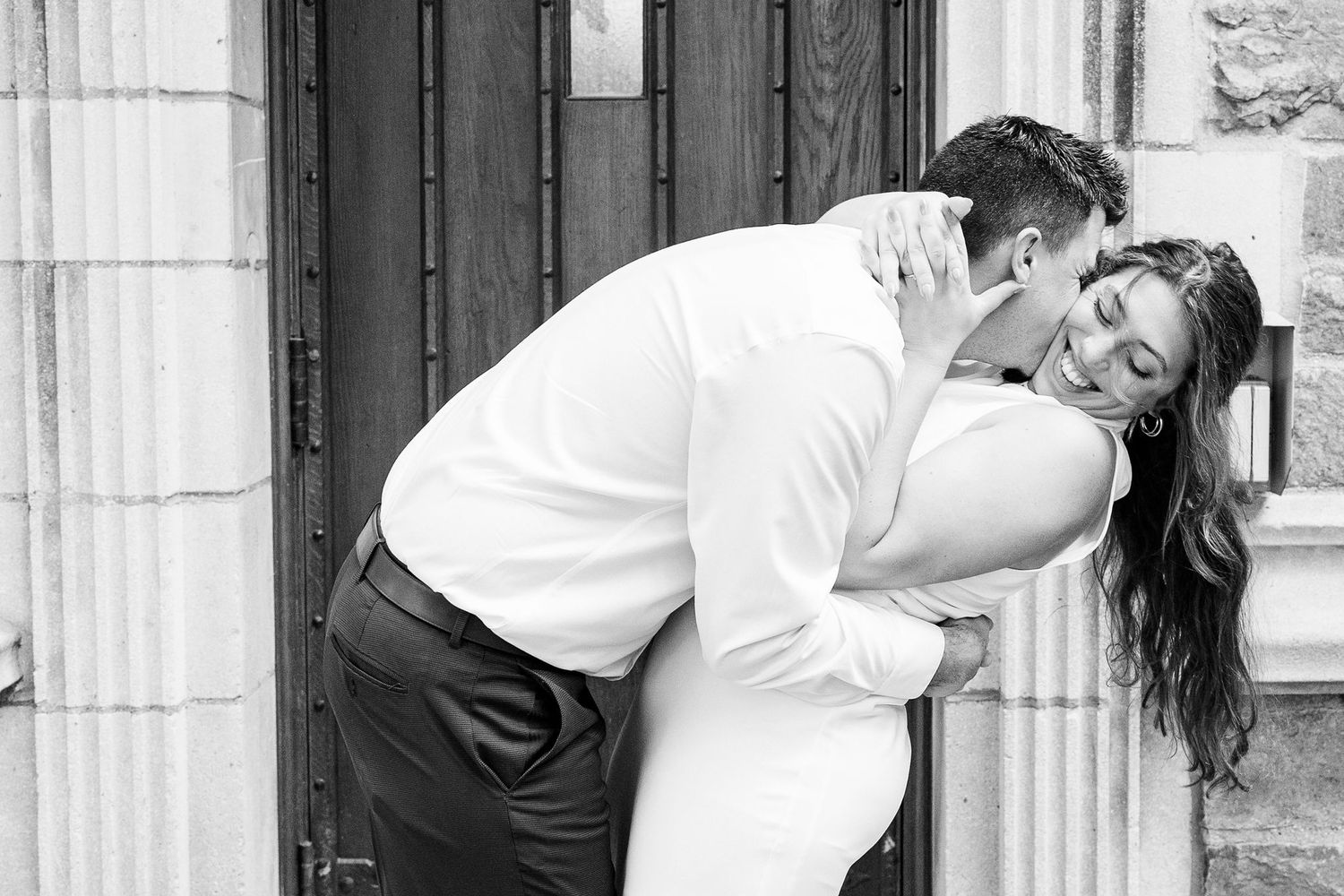 Engaged couple embracing at the University of Michigan Law Quad engagement session in Ann Arbor, MI