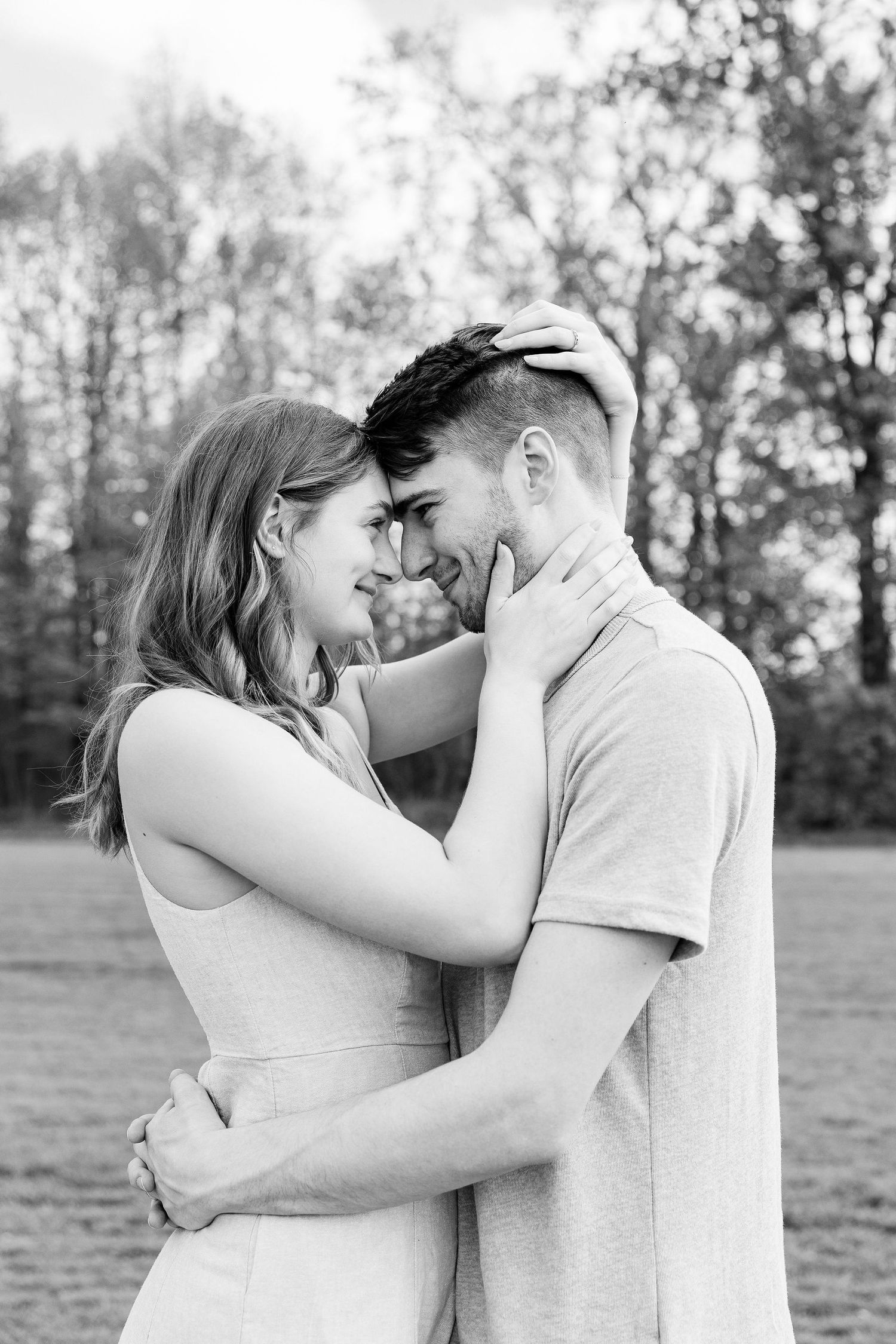 Engaged couple embracing at DeBuck's tulip field spring engagement session in Belleville, MI