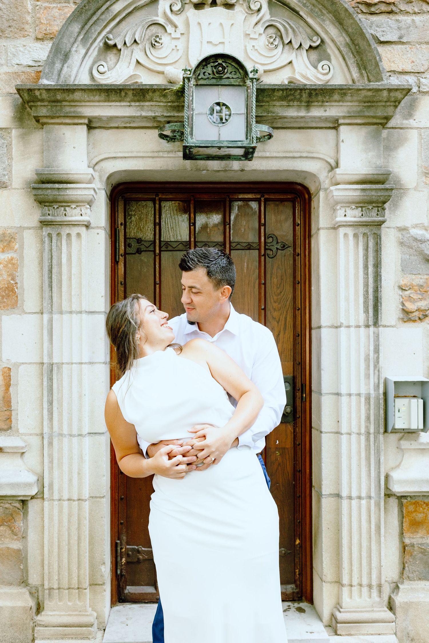 Engaged couple embracing at the University of Michigan Law Quad engagement session in Ann Arbor, MI