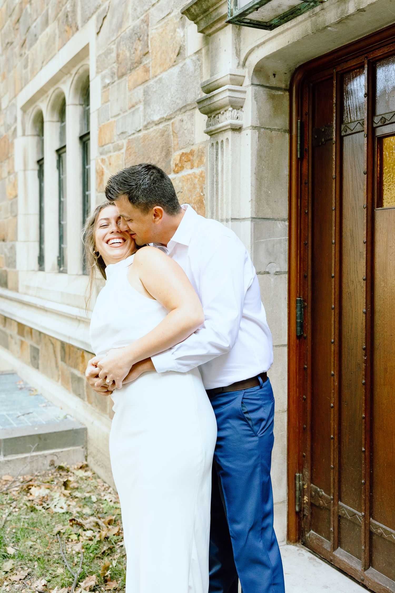 Engaged couple embracing at the University of Michigan Law Quad engagement session in Ann Arbor, MI