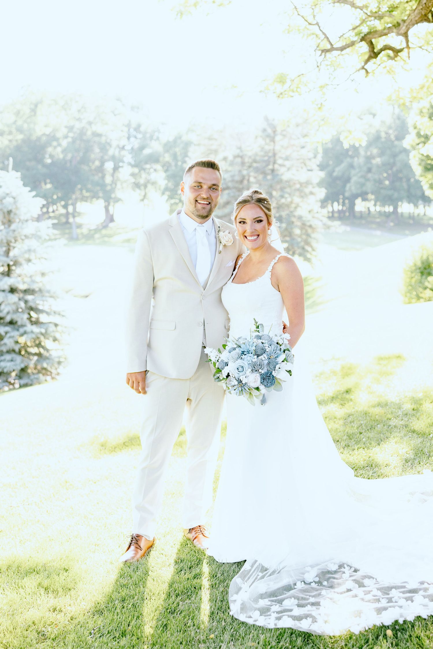 Married couple embracing at Lapeer Country Club wedding in Michigan